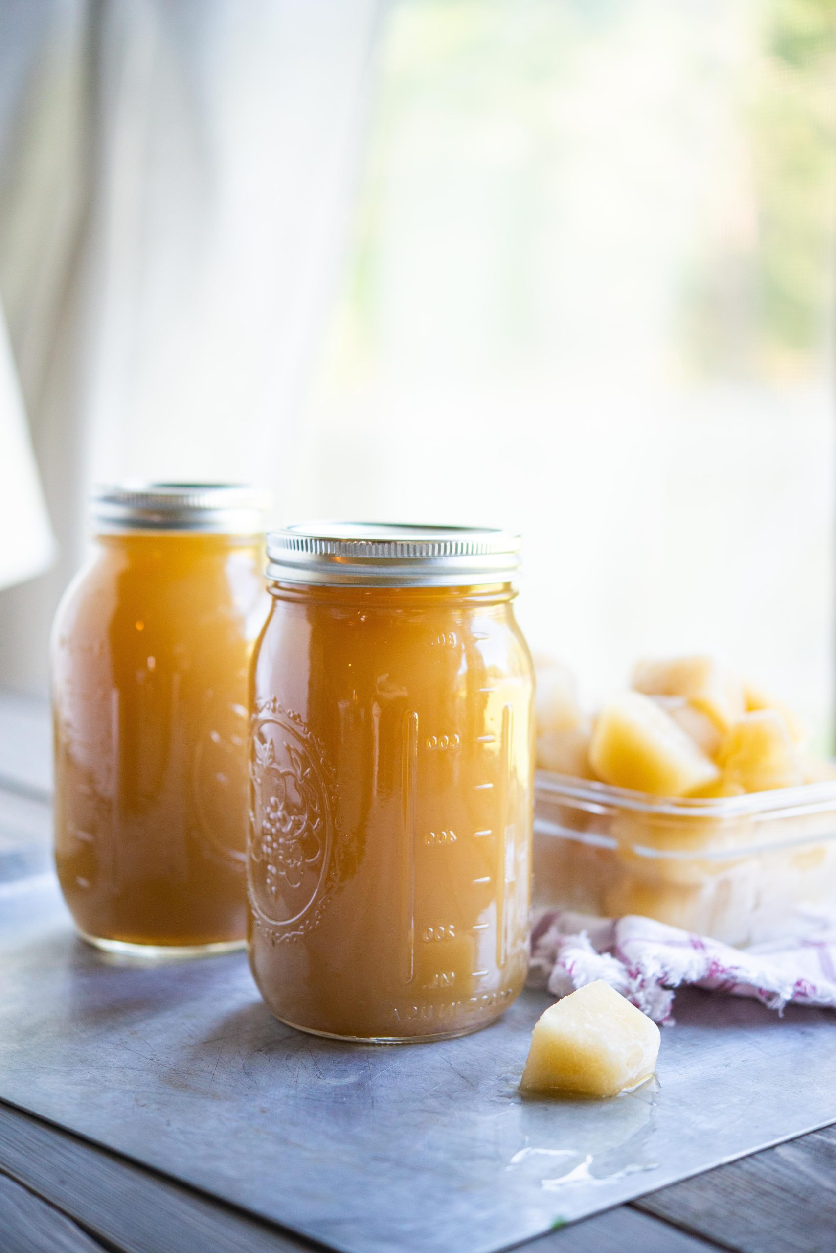 bone broth in a mason jar with bone broth cubes behind it