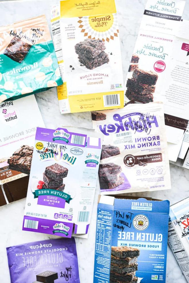 Der beste Brownie-Mix – Die Suche nach den besten glutenfreien Brownies 4 Schachteln mit verschiedenen Brownie-Backmischungen auf einer Marmoroberfläche