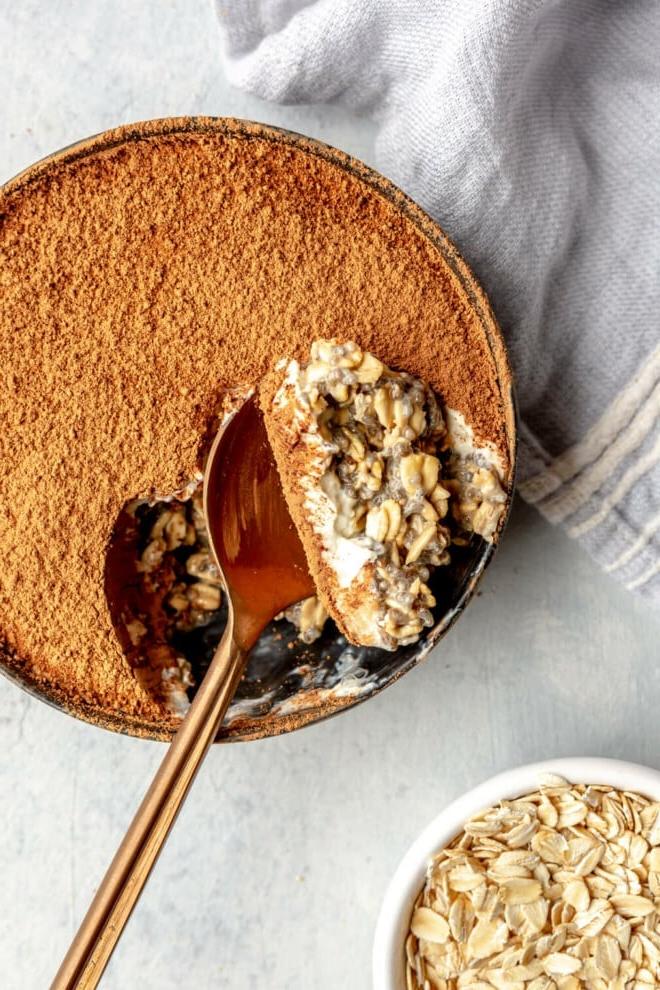 Tiramisu Overnight Oats 5 Draufsicht auf eine Schale Overnight Oats, aus der ein Löffel voll entnommen wurde.