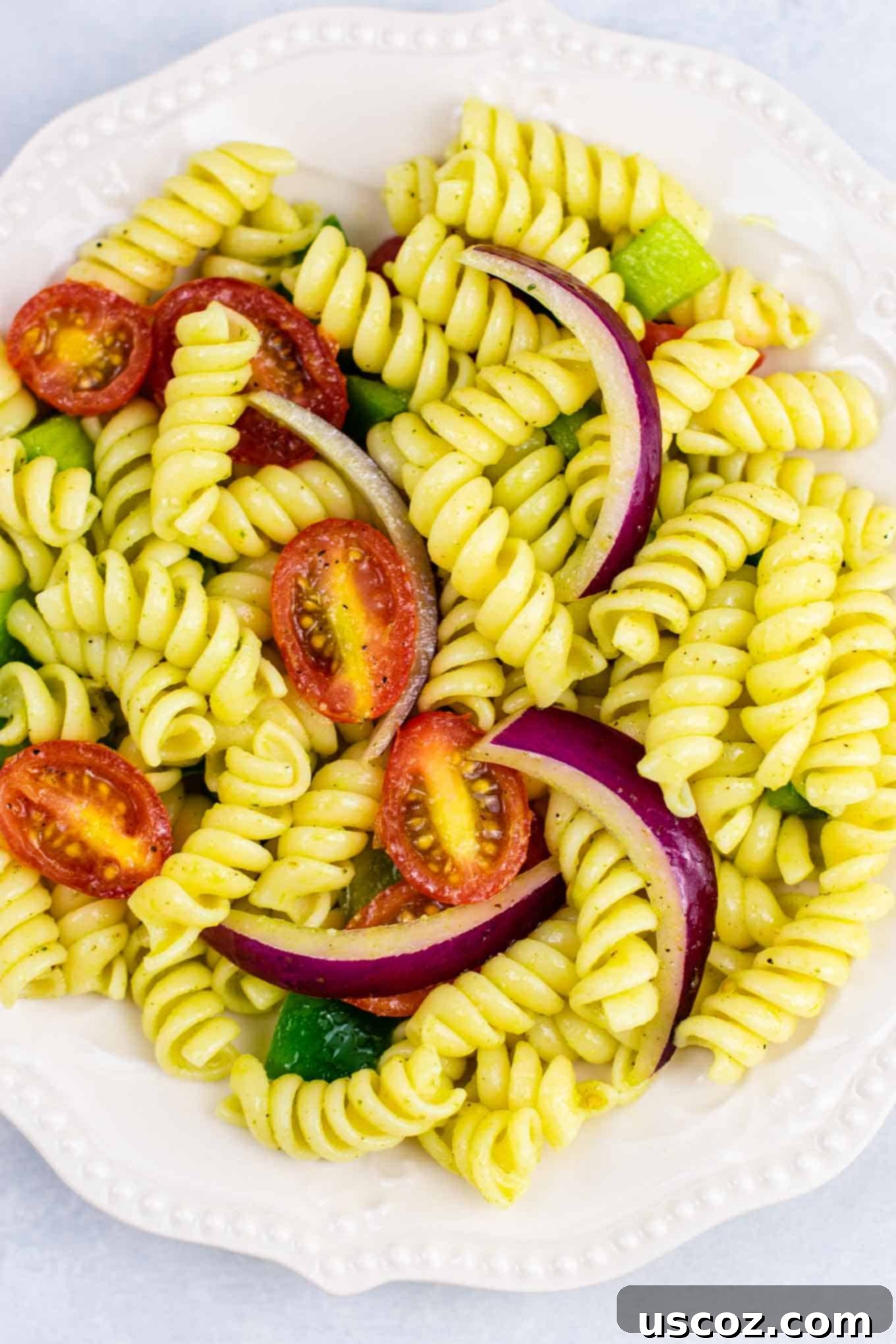 Vegan Pasta Salad 10 A top-down view of a serving of vegan pasta salad in a white bowl, garnished with fresh parsley, highlighting its simple beauty.