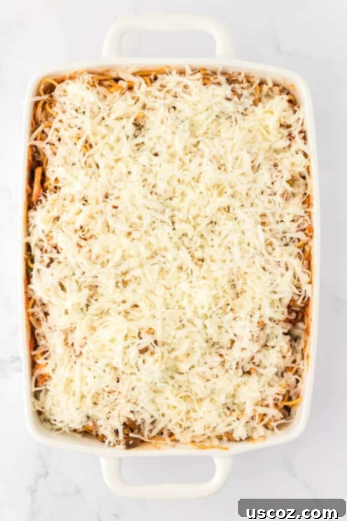 Hearty Vegetarian Spaghetti Bake 17 The spaghetti bake topped with a generous layer of mozzarella cheese, ready for baking