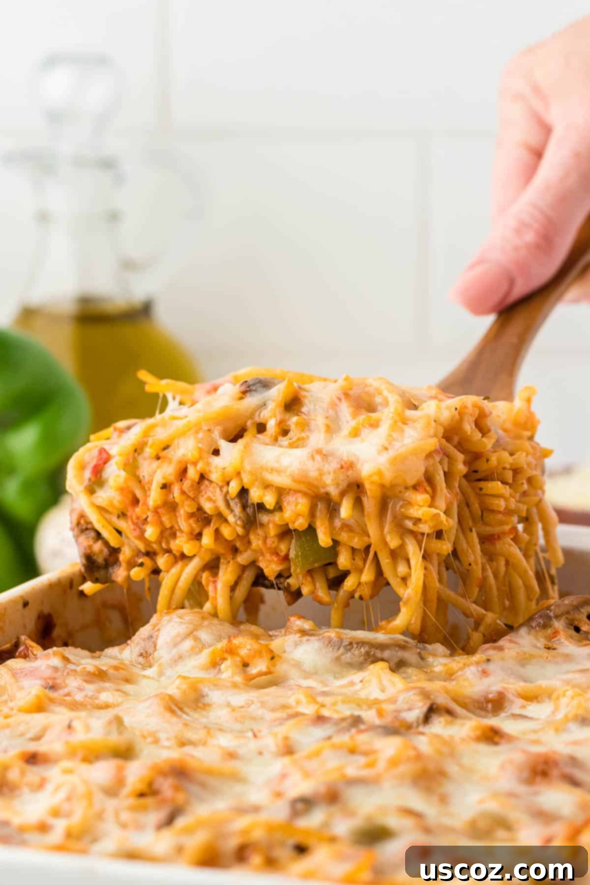 Hearty Vegetarian Spaghetti Bake 21 A large serving of vegetarian baked spaghetti in a white bowl, garnished with fresh basil