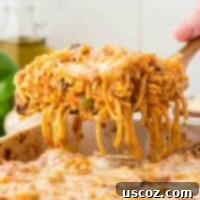 Hearty Vegetarian Spaghetti Bake 24 taking a serving of spaghetti bake from the dish