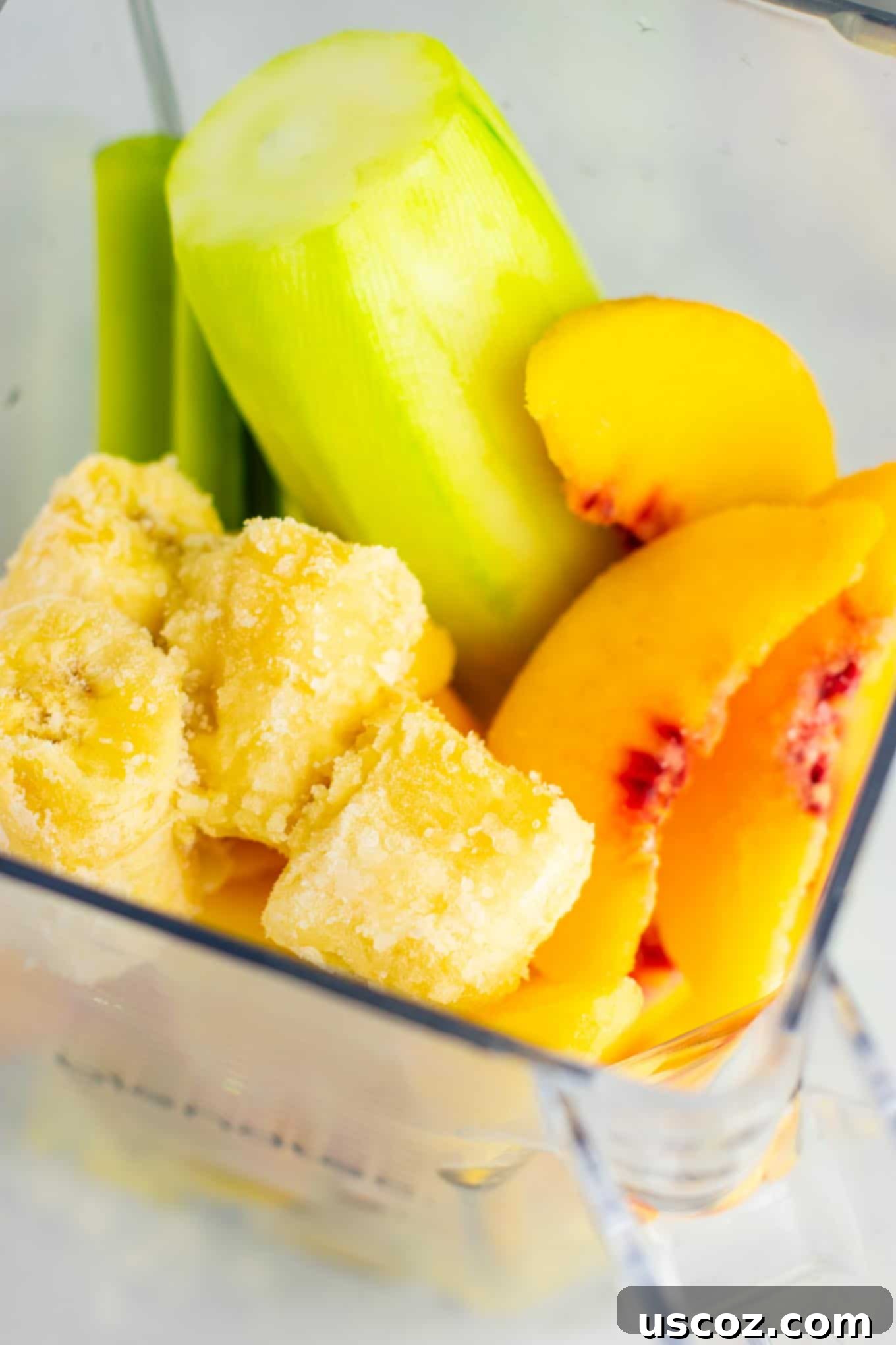 Pineapple detox smoothie with cucumbers, celery, lemon, peaches, ginger, and frozen bananas. 