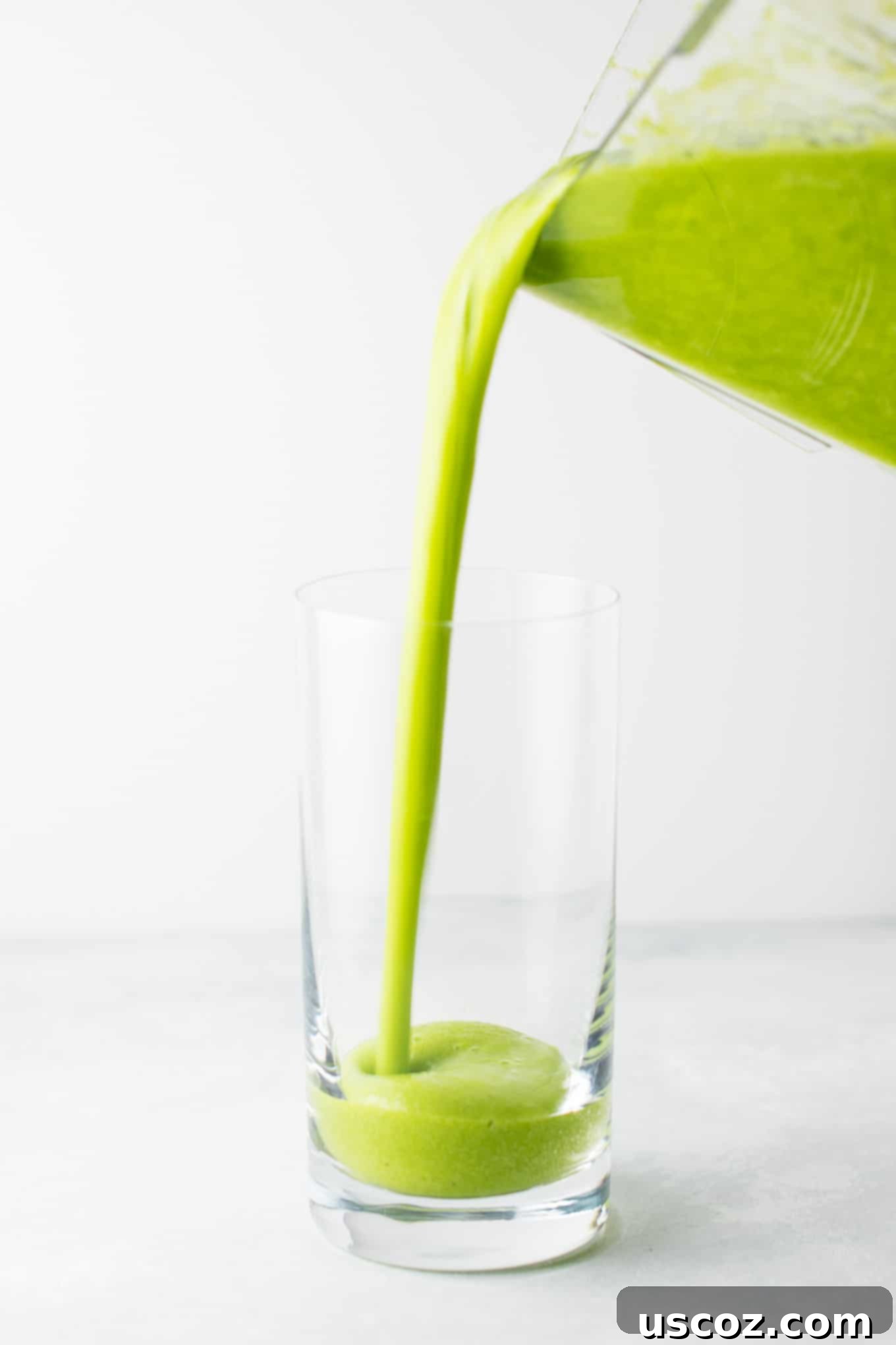 The BEST EVER green smoothie recipe made with kale, ginger, oranges, lemon, frozen banana, frozen peaches, and water. A ridiculously good for you delicious green smoothie that the whole family will love! #greensmoothierecipe #vegan #kale #drinks