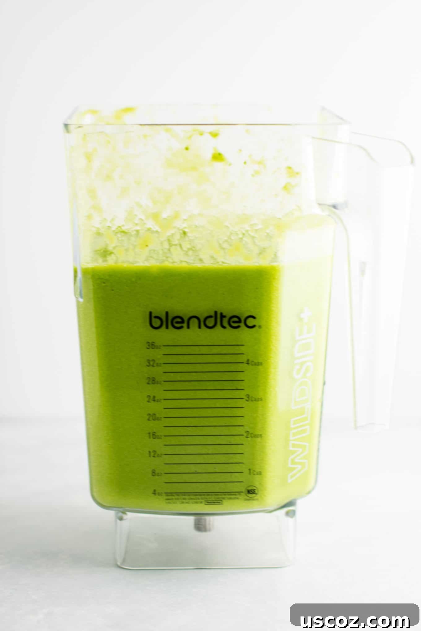 The BEST EVER green smoothie recipe made with kale, ginger, oranges, lemon, frozen banana, frozen peaches, and water. A ridiculously good for you delicious green smoothie that the whole family will love! #greensmoothierecipe #vegan #kale #drinks