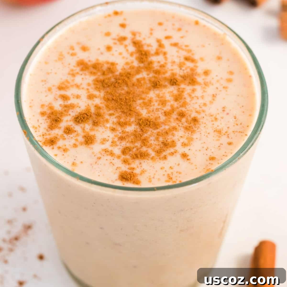 Liquid Apple Pie 2 Glass of healthy apple pie smoothie topped with cinnamon and a slice of apple, perfect for a fall treat