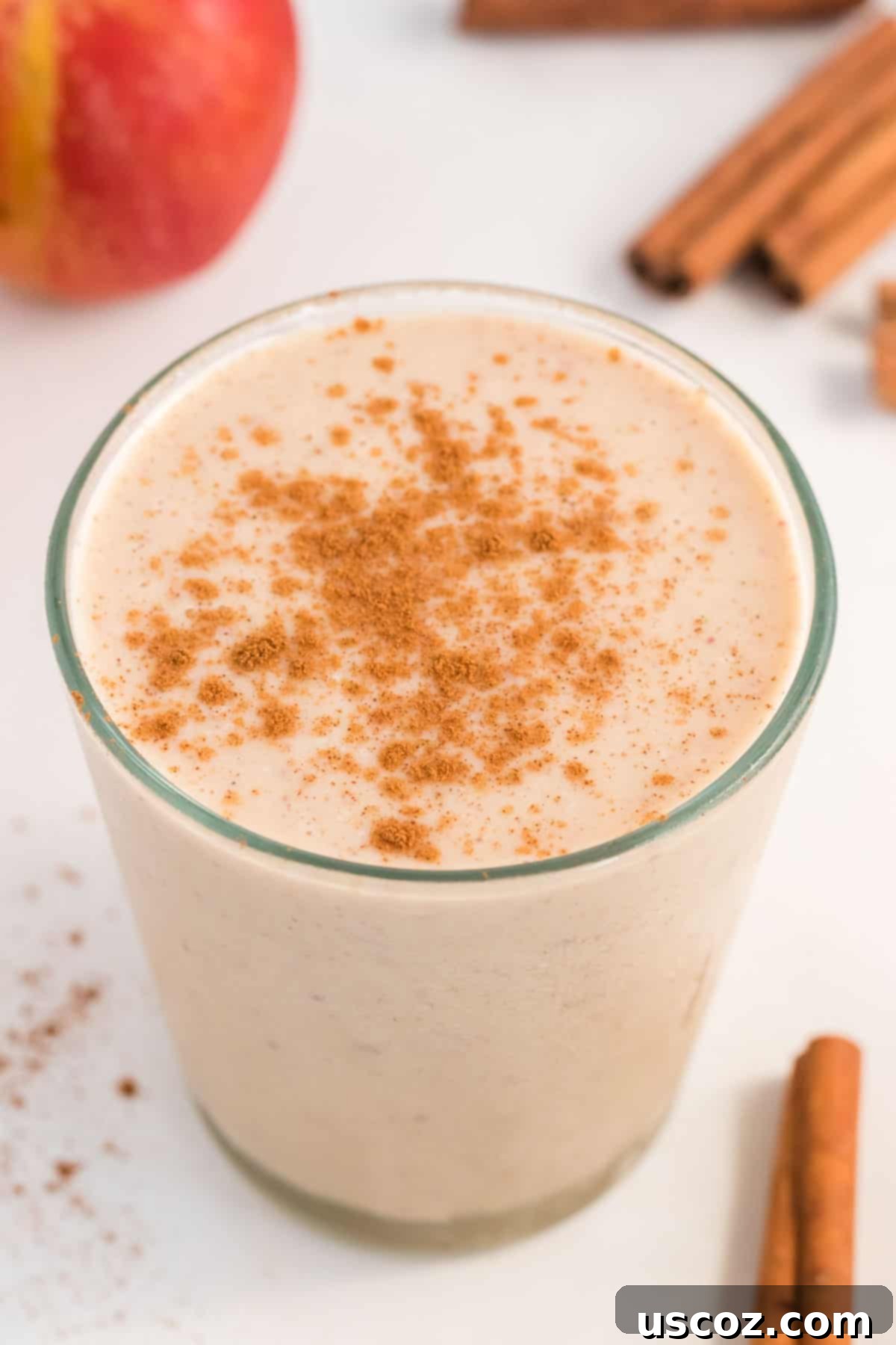 Liquid Apple Pie 7 Close-up of a glass of apple pie smoothie, showing the thick, creamy texture and cinnamon topping