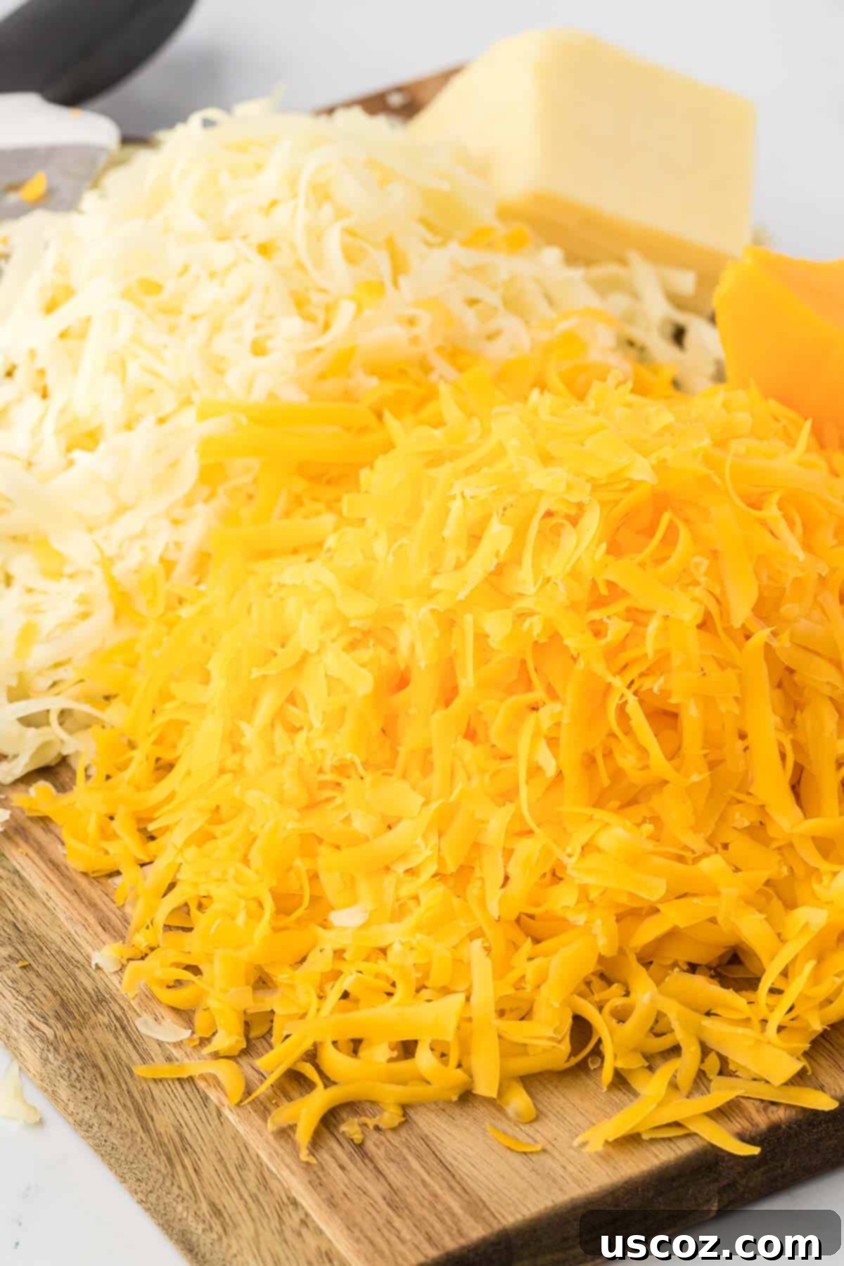 Creamy Instant Pot Mac and Cheese 4 freshly grated cheese on a cutting board