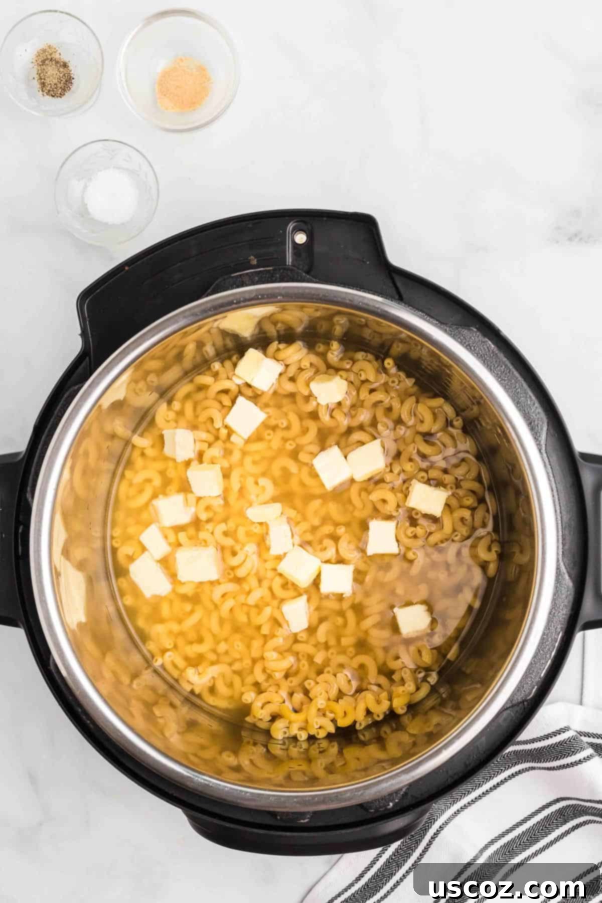 Creamy Instant Pot Mac and Cheese 6 cubed butter and liquid with macaroni in an instant pot