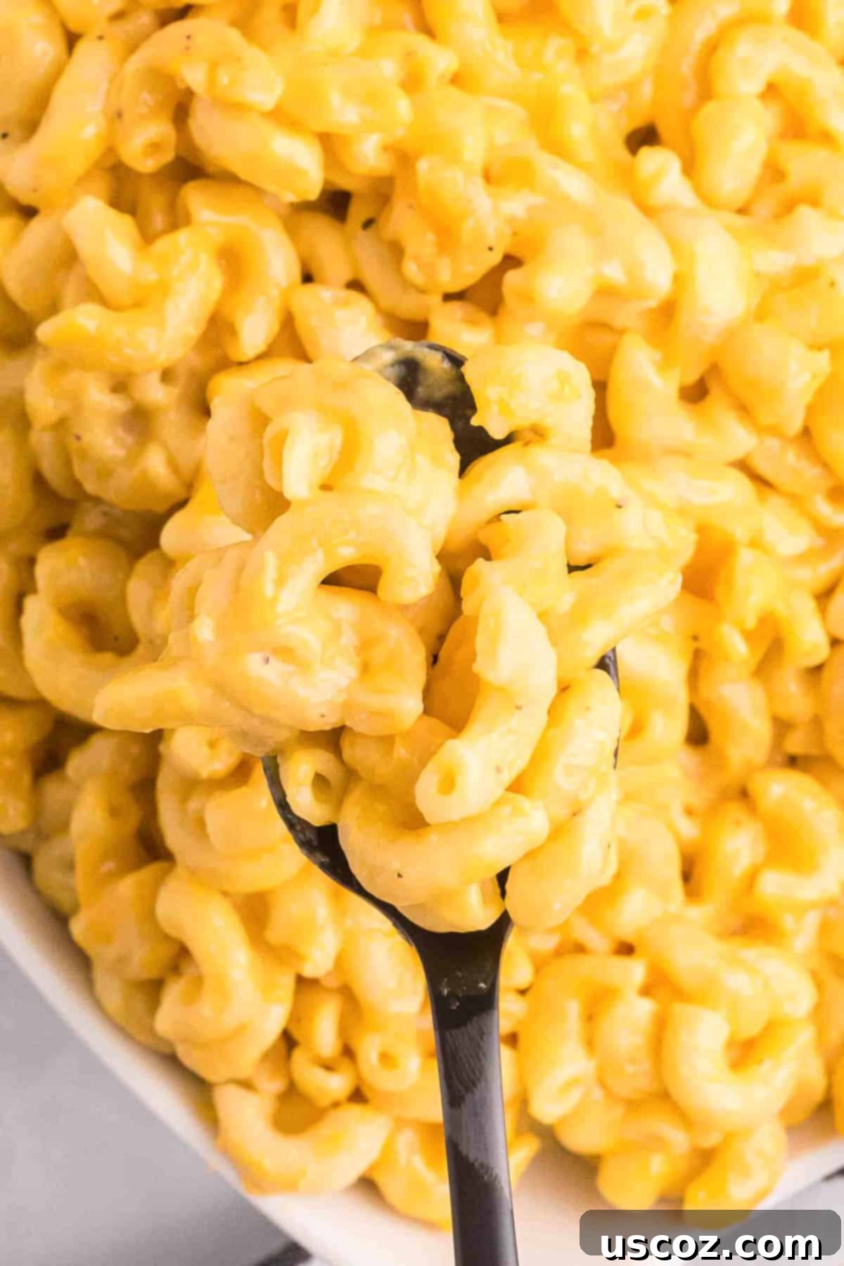 Creamy Instant Pot Mac and Cheese 9 spoon taking a scoop of instant pot mac and cheese