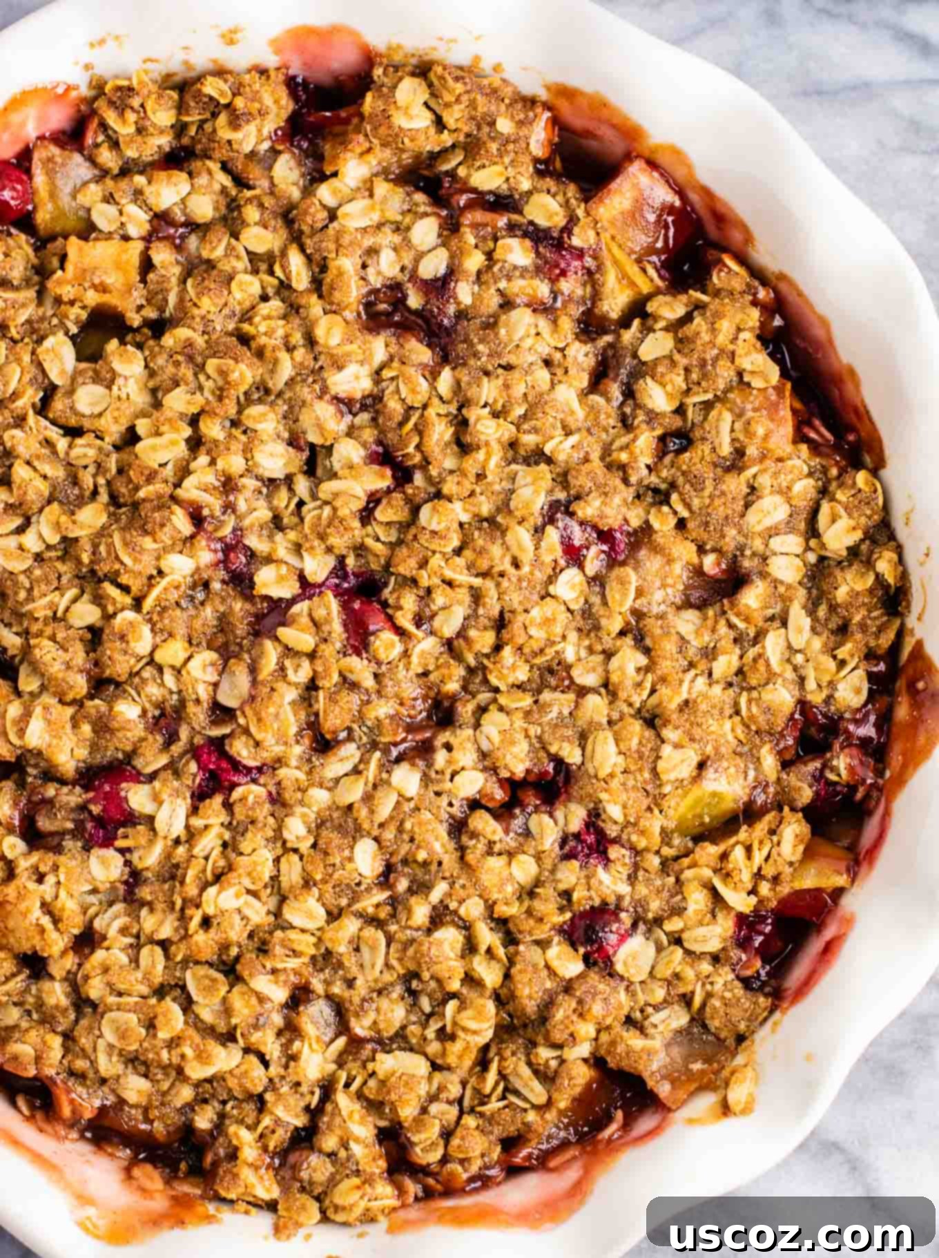 Spiced Cranberry Apple Crumble 5 Close-up of the crumbly, golden-brown crisp topping ingredients in a bowl, ready to be spread.