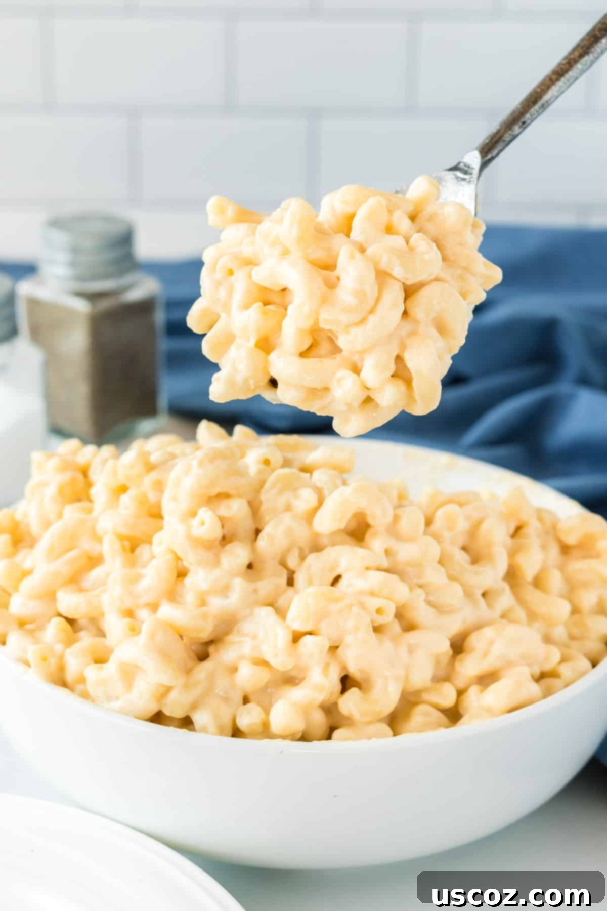 36 Delicious Vegetarian Thanksgiving Dishes 21 A spoon taking a scoop of Greek yogurt mac and cheese from a bowl, showing its creamy texture