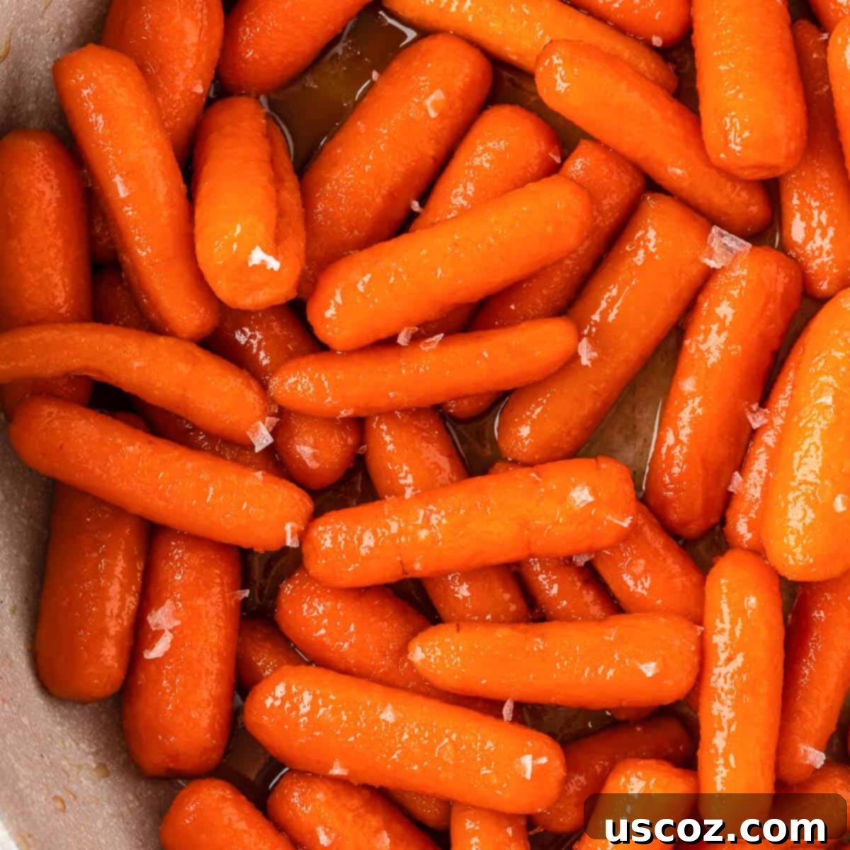 36 Delicious Vegetarian Thanksgiving Dishes 22 Honey brown sugar glazed carrots in a serving dish, glistening with glaze