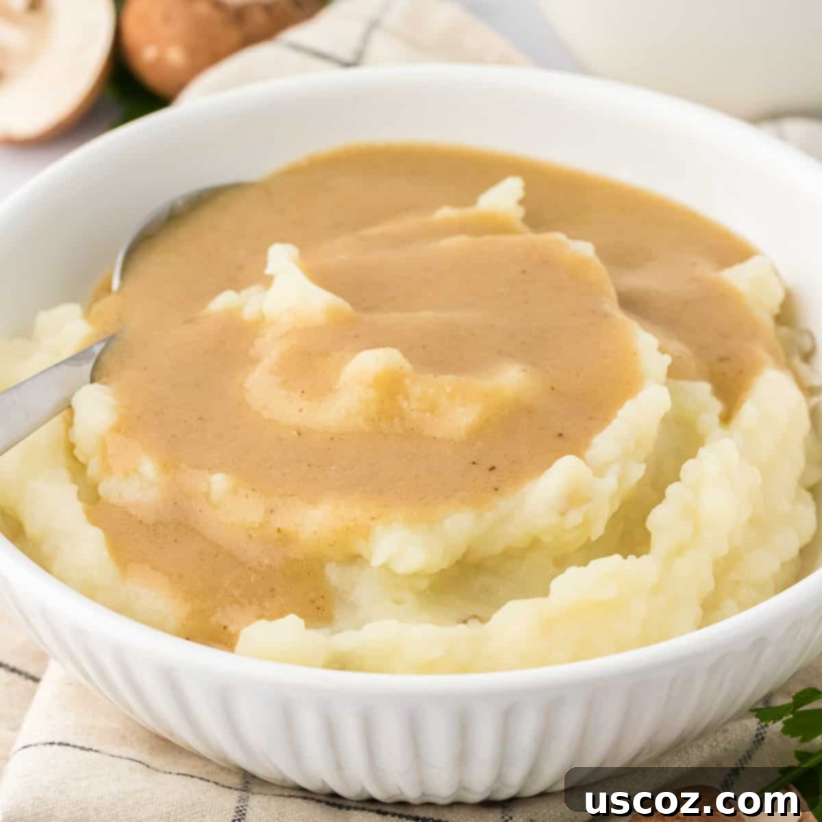 36 Delicious Vegetarian Thanksgiving Dishes 7 bowl of creamy mashed potatoes generously topped with homemade vegetarian gravy