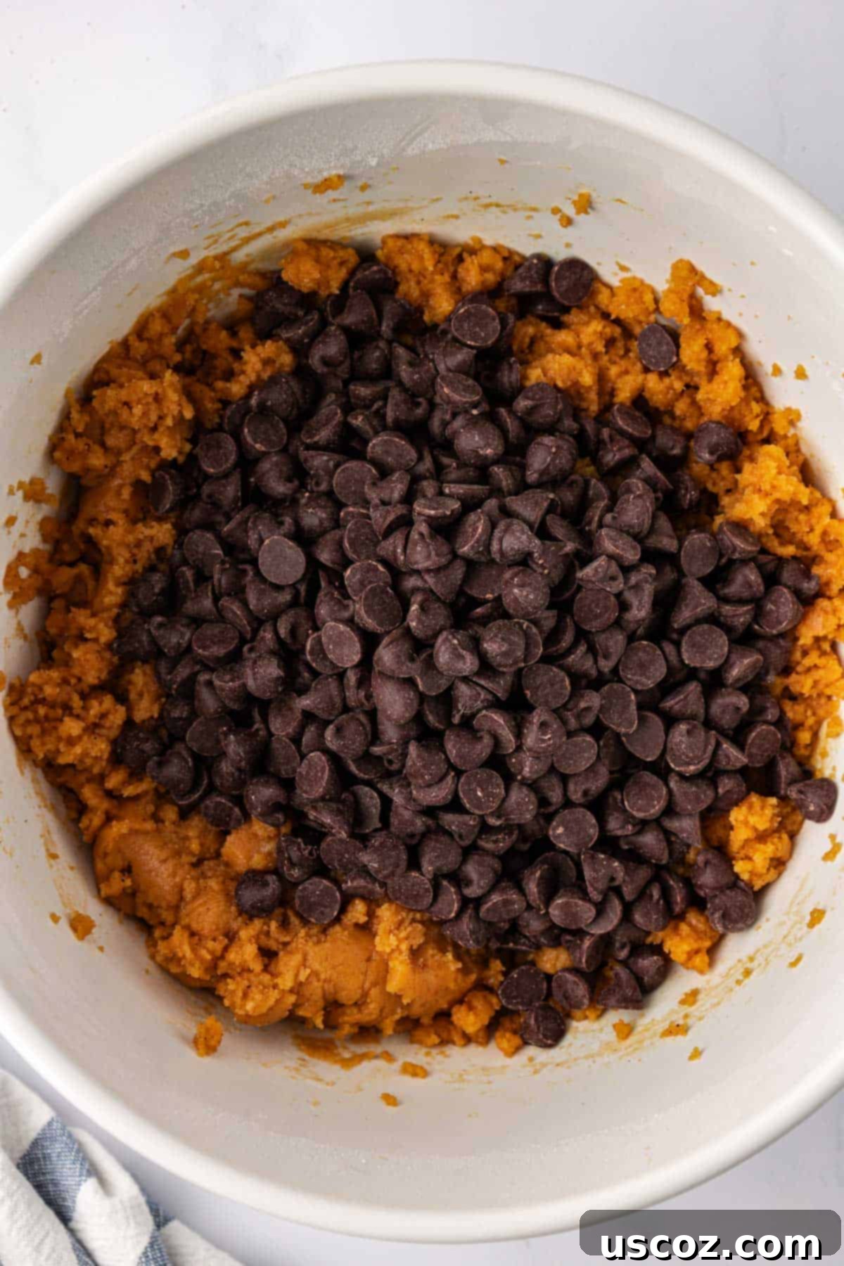 Cozy Vegan Pumpkin Chocolate Chip Cookies 11 Dairy-free chocolate chips being folded into the vegan pumpkin cookie batter.