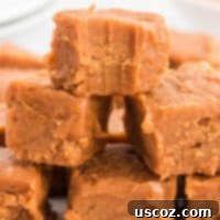 Rich peanut butter fudge with a bite taken out, showing its creamy texture and tempting deliciousness.