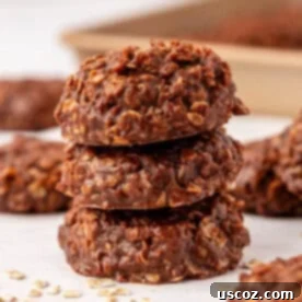 A stack of healthy no bake cookies, clearly showing their rich chocolate and peanut butter layers.
