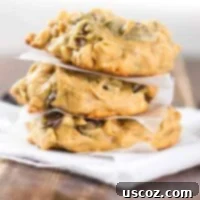 A stack of perfectly baked peanut butter oatmeal chocolate chip cookies, showcasing their inviting texture and rich flavor. These are easy and gluten-free.