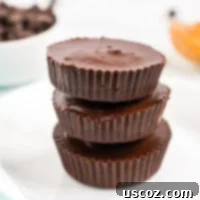 A tempting stack of vegan peanut butter cups, highlighting their irresistible combination of chocolate and creamy peanut butter.