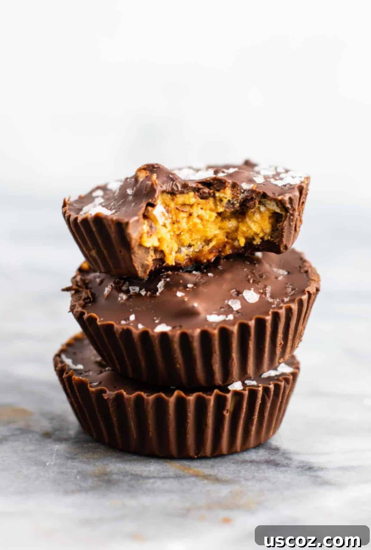 Chocolate peanut butter crunch cups with flaked sea salt – these are next level DELICIOUS! Vegan, gluten free, and tastes so good you won’t want to share! Perfect treat to keep in the freezer! #vegan #glutenfree #dessert #reesescups #vegandessert #glutenfreedessert #christmas #holidaytreat #seasalt