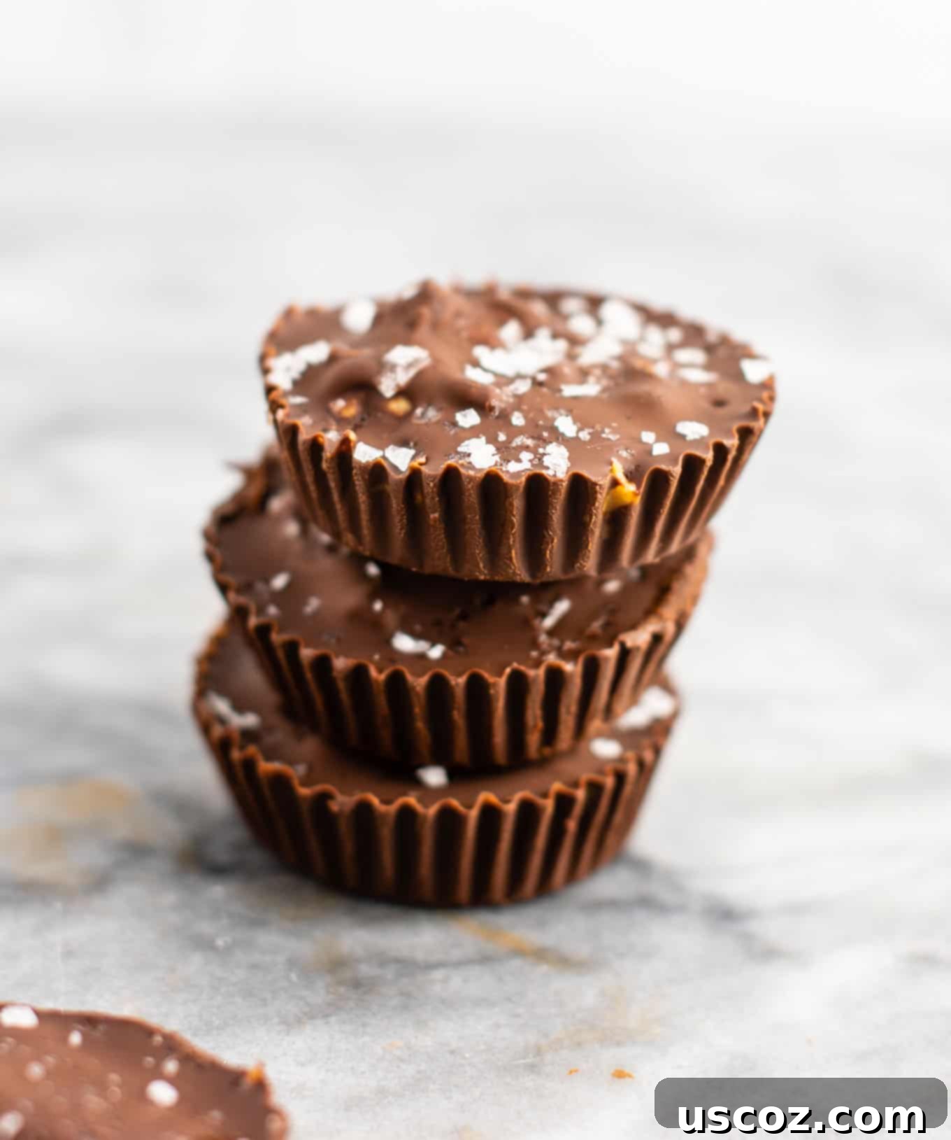 Chocolate peanut butter crunch cups with flaked sea salt – these are next level DELICIOUS! Vegan, gluten free, and tastes so good you won’t want to share! Perfect treat to keep in the freezer! #vegan #glutenfree #dessert #reesescups #vegandessert #glutenfreedessert #christmas #holidaytreat #seasalt