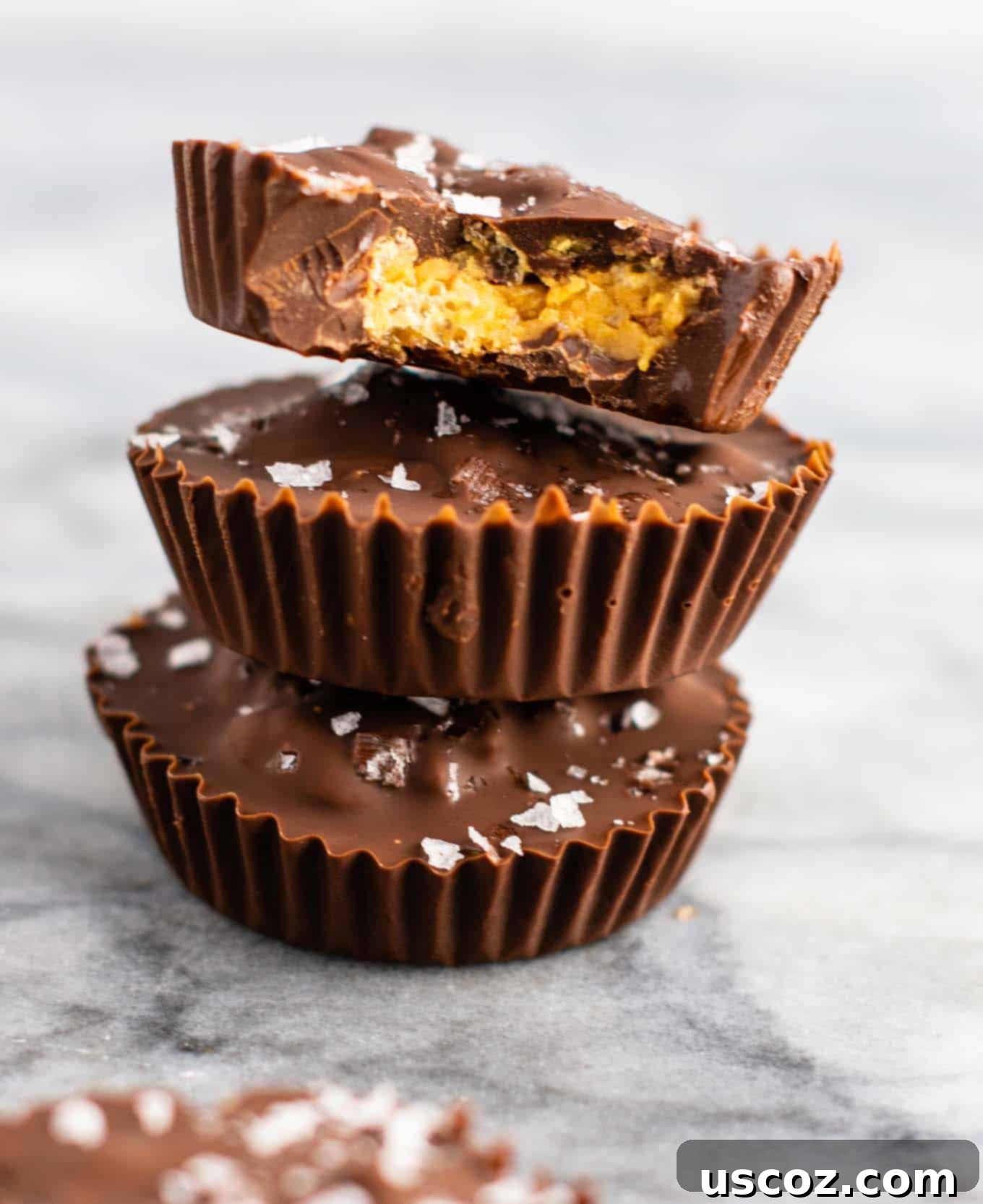 Chocolate peanut butter crunch cups with flaked sea salt – these are next level DELICIOUS! Vegan, gluten free, and tastes so good you won’t want to share! Perfect treat to keep in the freezer! #vegan #glutenfree #dessert #reesescups #vegandessert #glutenfreedessert #christmas #holidaytreat #seasalt
