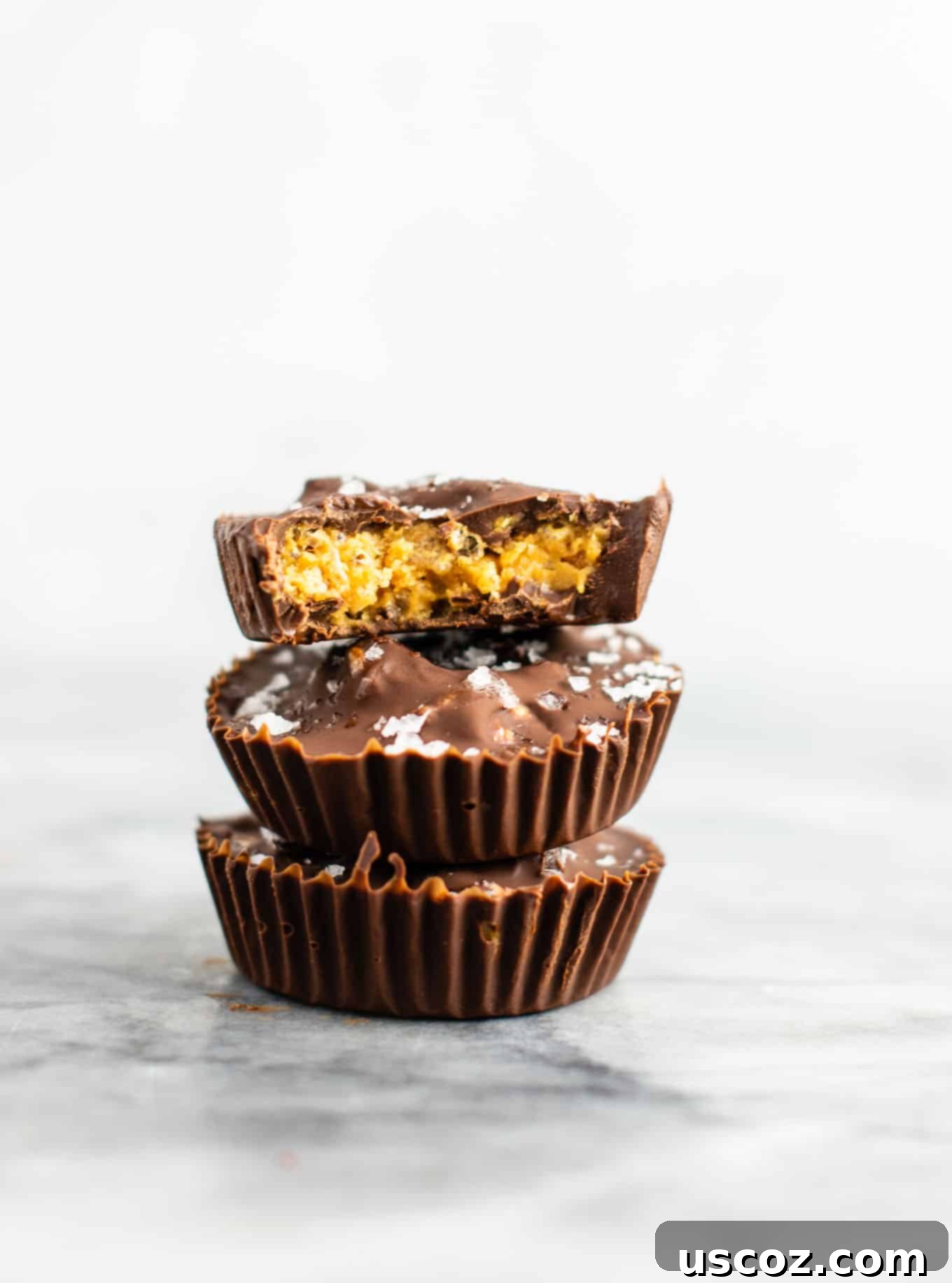 Chocolate peanut butter crunch cups with flaked sea salt – these are next level DELICIOUS! Vegan, gluten free, and tastes so good you won’t want to share! Perfect treat to keep in the freezer! #vegan #glutenfree #dessert #reesescups #vegandessert #glutenfreedessert #christmas #holidaytreat #seasalt