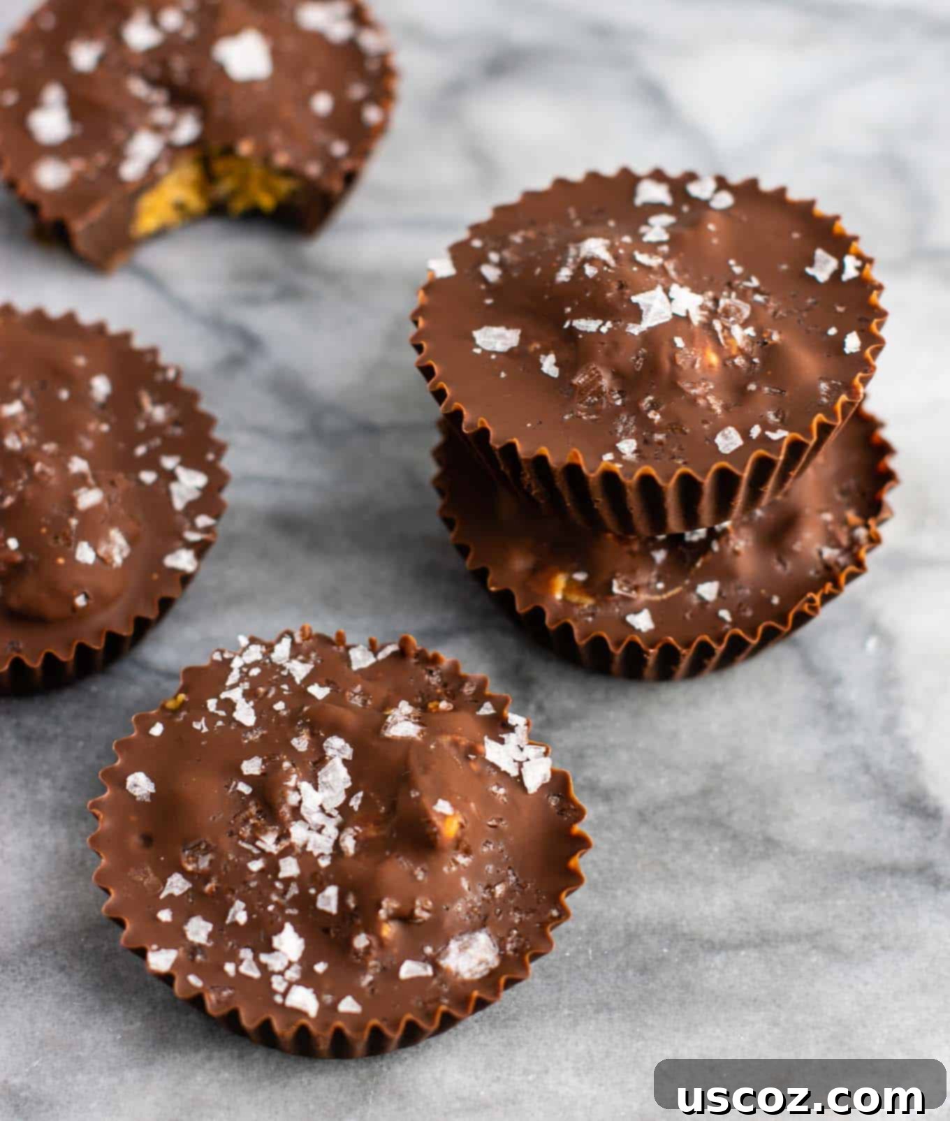 Chocolate peanut butter crunch cups with flaked sea salt – these are next level DELICIOUS! Vegan, gluten free, and tastes so good you won’t want to share! Perfect treat to keep in the freezer! #vegan #glutenfree #dessert #reesescups #vegandessert #glutenfreedessert #christmas #holidaytreat #seasalt