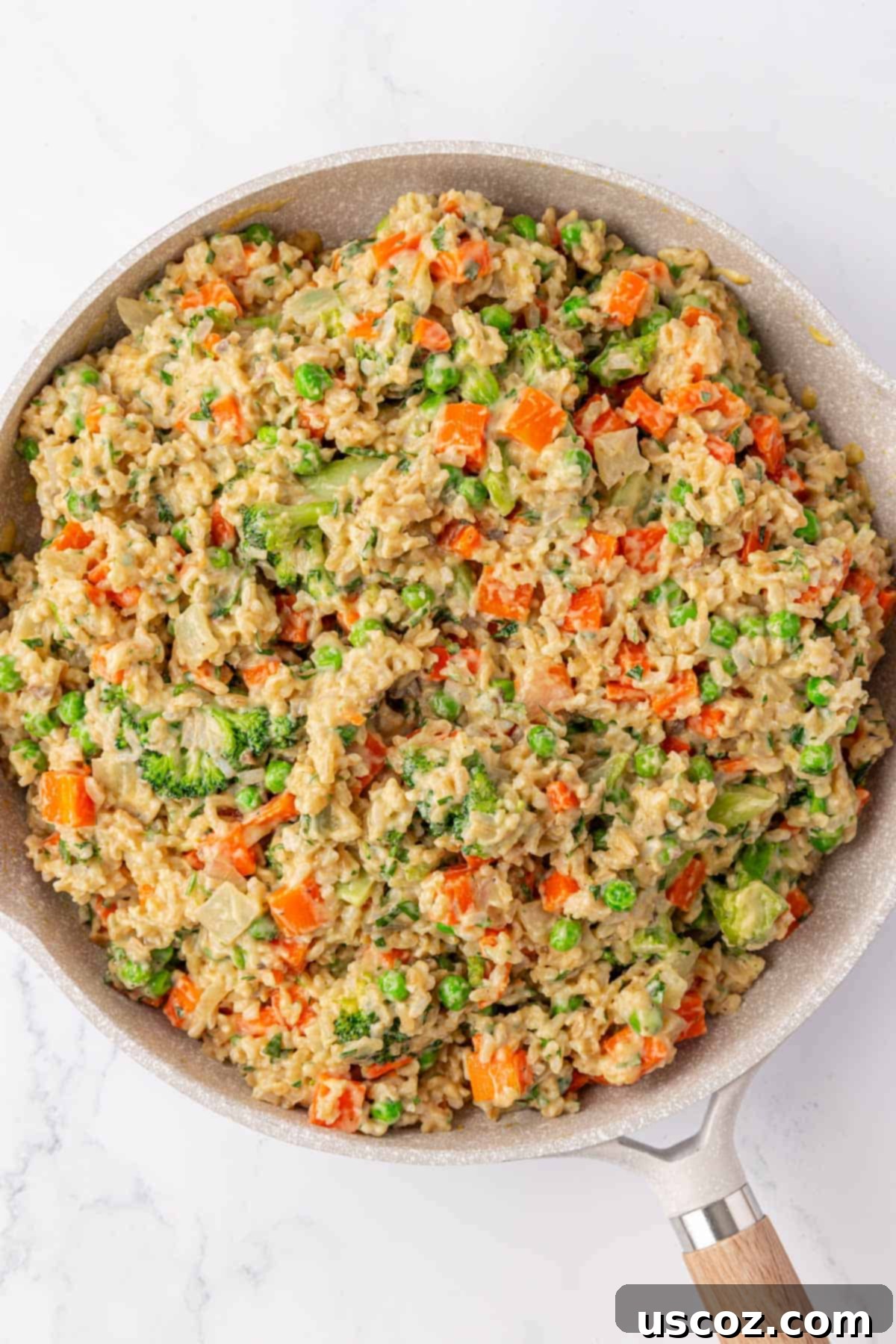 Hearty Veggie Rice Bake 12 The fully mixed vegetable rice casserole filling in a skillet, ready for baking