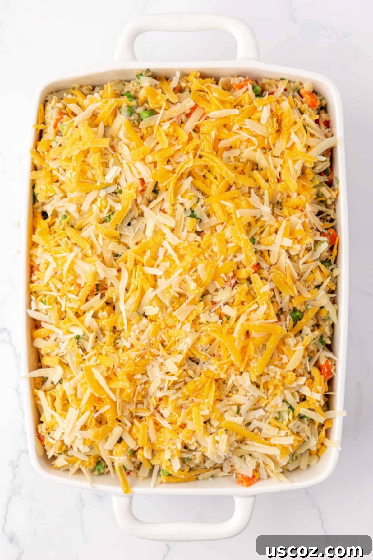 Hearty Veggie Rice Bake 13 Topping the vegetable rice casserole with a generous layer of grated cheese before baking