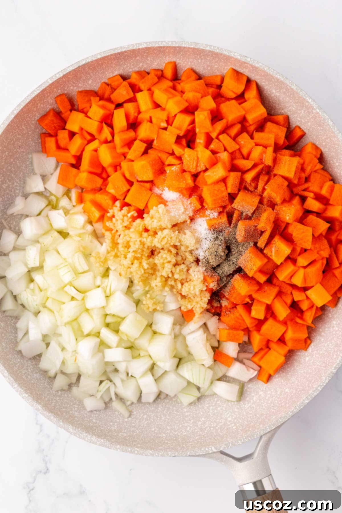 Hearty Veggie Rice Bake 5 Carrots, onions, garlic, and spices cooking in a large skillet