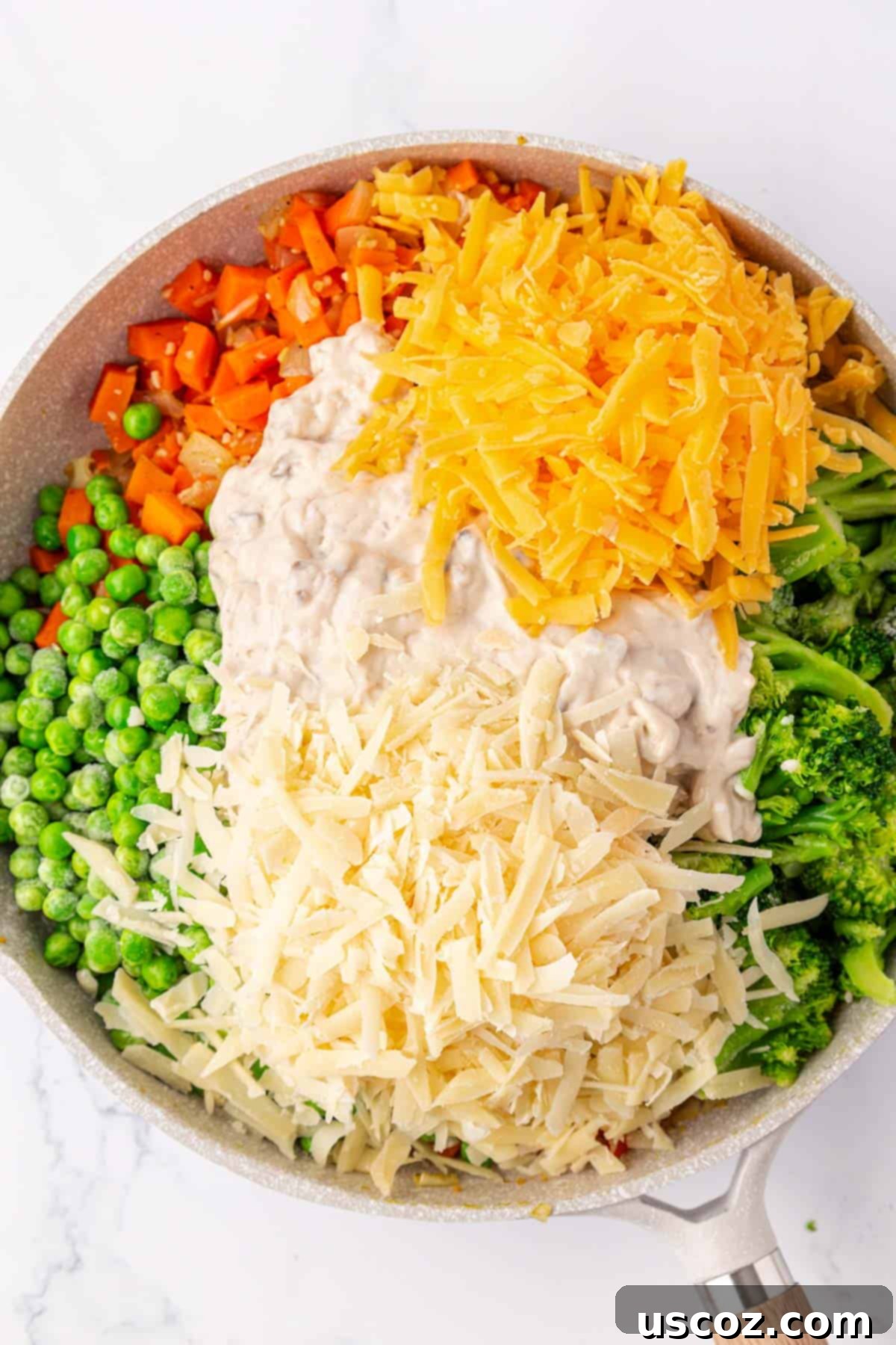 Hearty Veggie Rice Bake 8 Cream of mushroom soup and grated cheeses being added to the vegetable mixture in the skillet