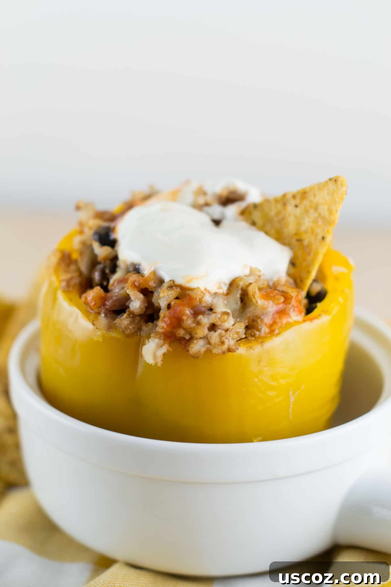 Platter of vegetarian crockpot stuffed peppers served with fresh lime, sour cream, and tortilla chips