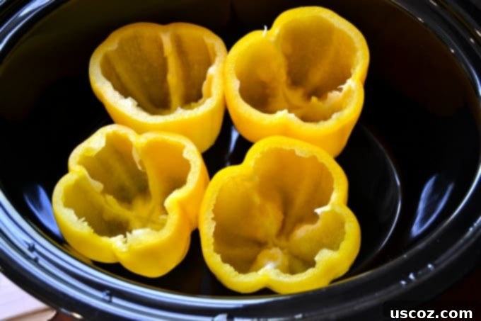 Four bell peppers with tops cut off and seeds removed, ready to be stuffed