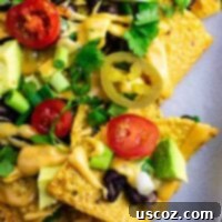 Epic Plant-Based Nachos 11 Loaded veggie nachos topped with homemade nacho cheese sauce. These are amazing! #veggienachos #vegetarian #nachocheese #nachocheesesauce