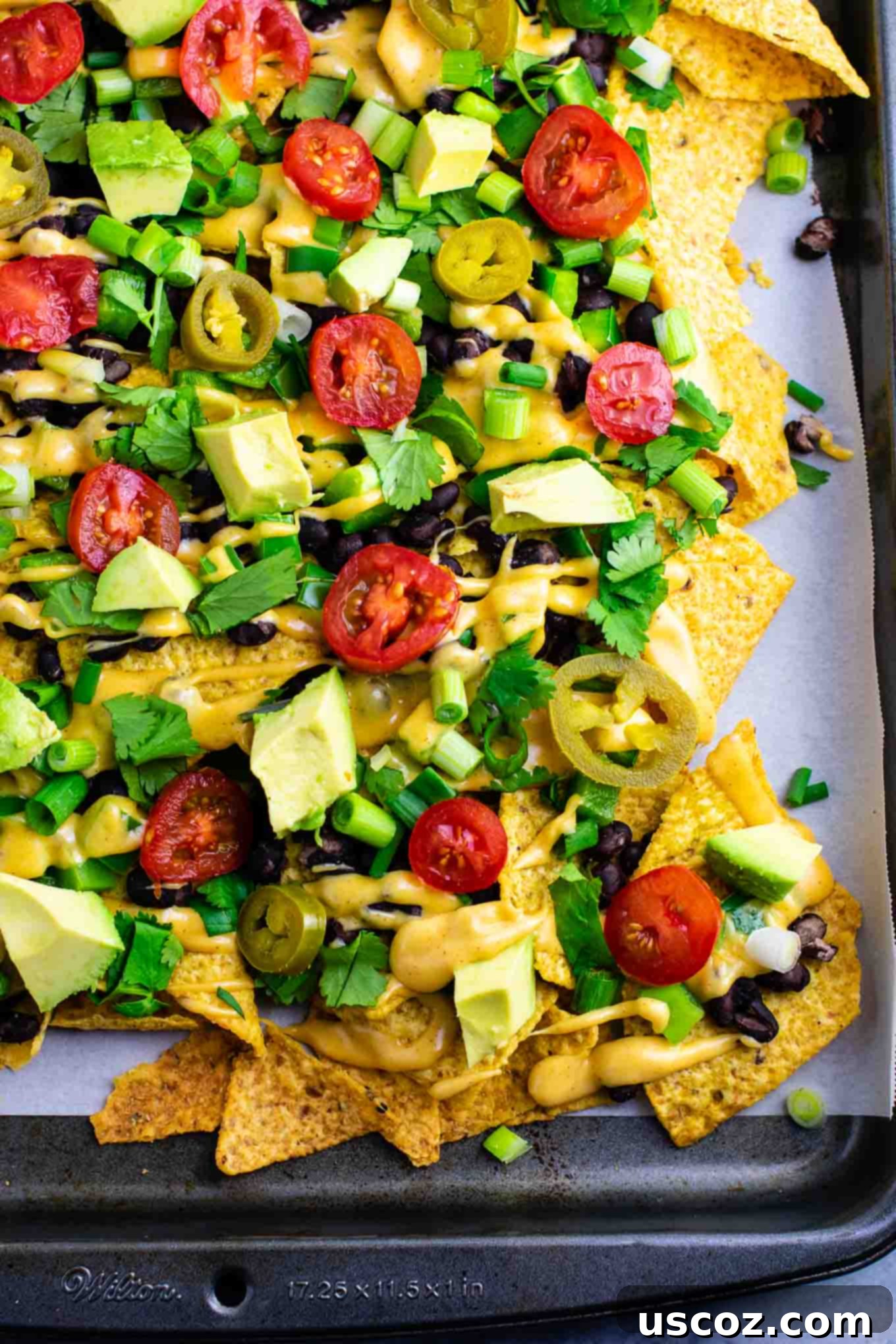 Epic Plant-Based Nachos 4 Loaded veggie nachos topped with homemade nacho cheese sauce. These are amazing! #veggienachos #vegetarian #nachocheese #nachocheesesauce