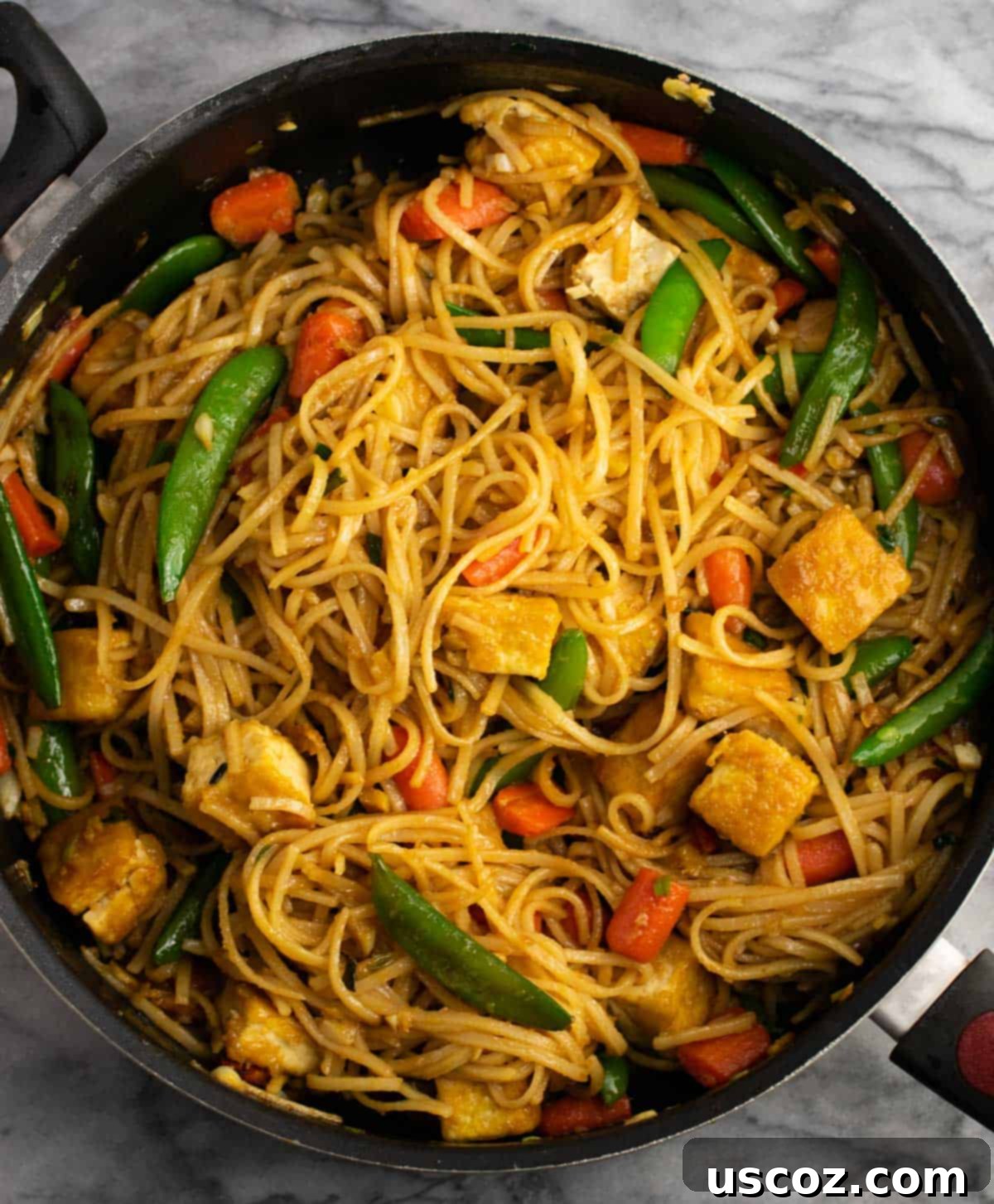 Vibrant Tofu Noodle Stir-Fry 2 Crispy tofu and noodle stir fry in a skillet, ready to serve.