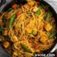Vibrant Tofu Noodle Stir-Fry 12 Crispy tofu and noodle stir fry in a skillet.