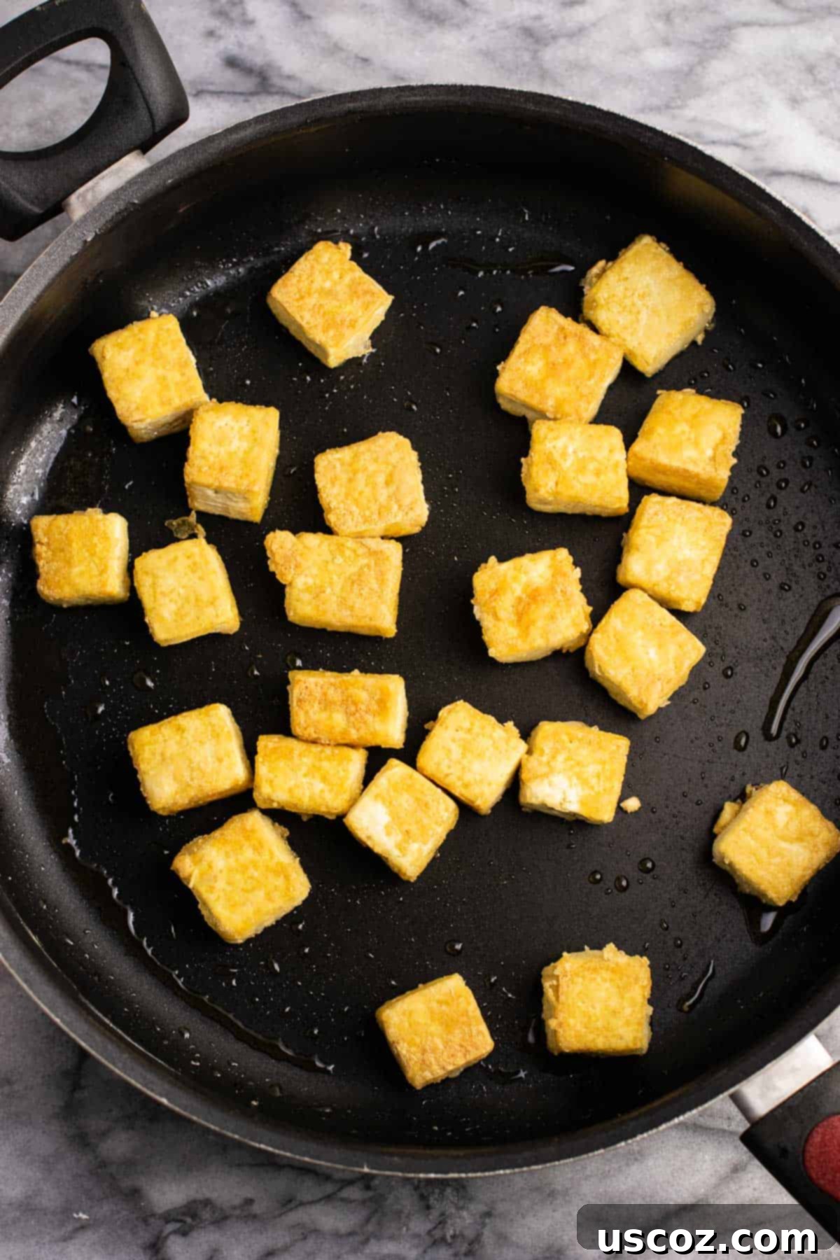 Vibrant Tofu Noodle Stir-Fry 4 Close-up of crispy, browned tofu cubes in a non-stick skillet.