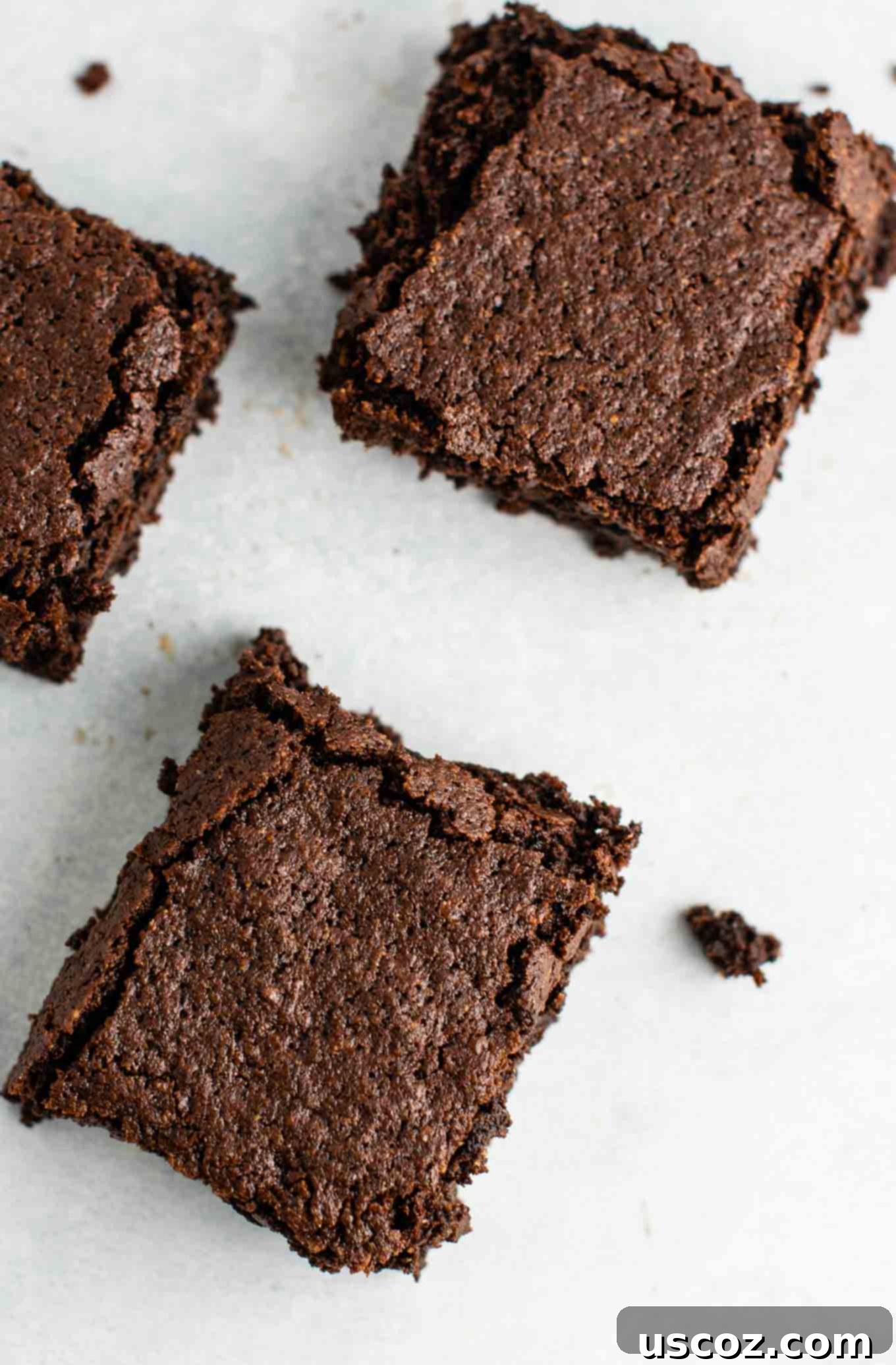 Close-up of freshly baked gluten-free dairy-free brownies, highlighting their moist, dense interior and glistening top.