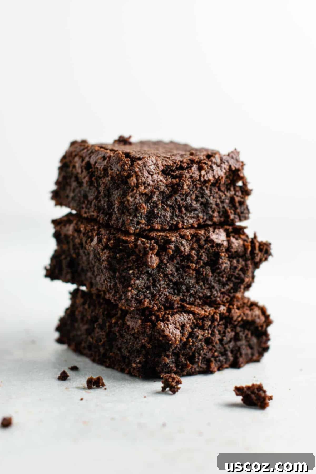 A stack of delicious gluten-free dairy-free brownies, showcasing their irresistible fudgy texture.