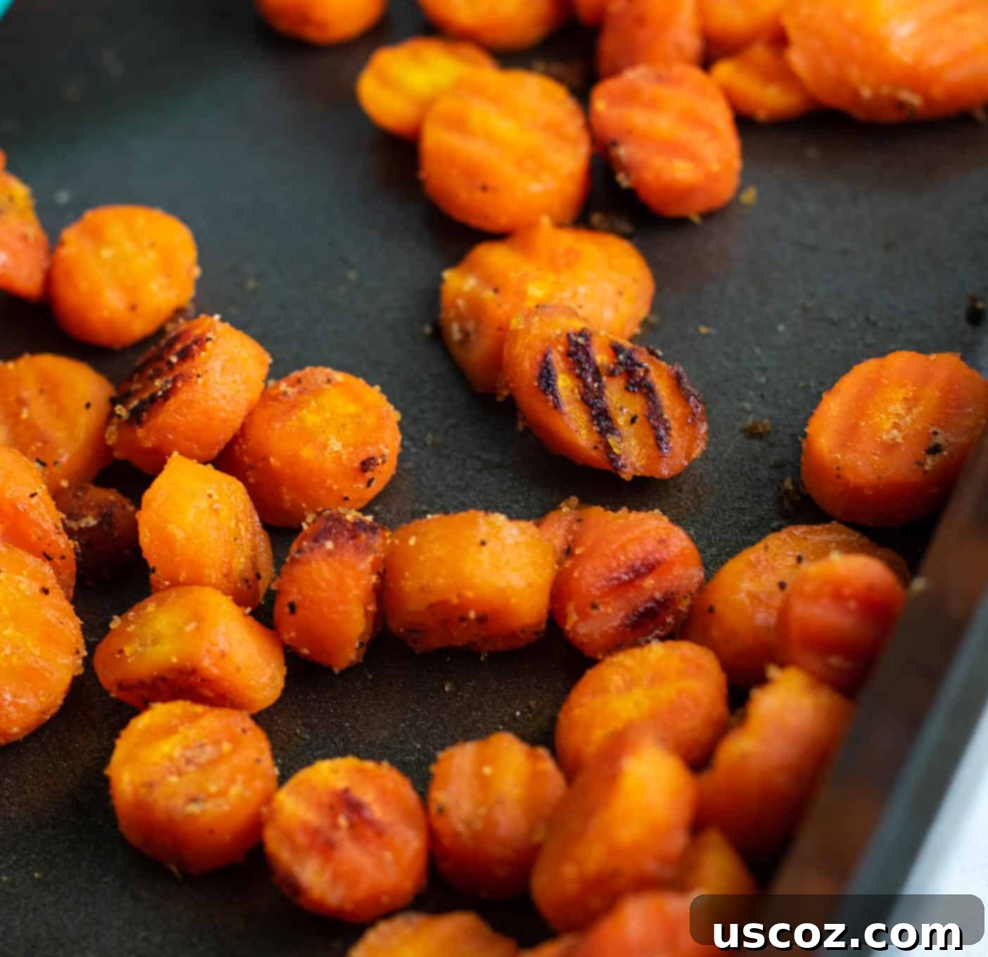 Simple & Delicious Frozen Carrot Dishes 5 Crinkle cut carrots scattered evenly on a baking sheet before roasting, showing their distinct shape.