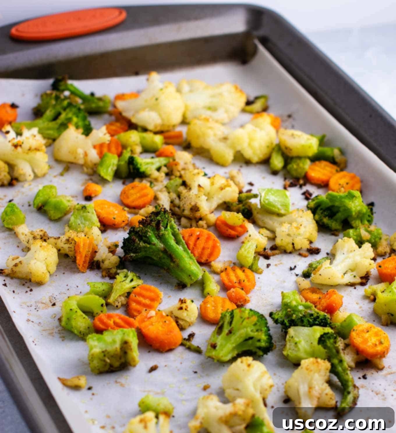 Easy Roasted Frozen Vegetables 2 roasted vegetables on a parchment paper lined baking sheet