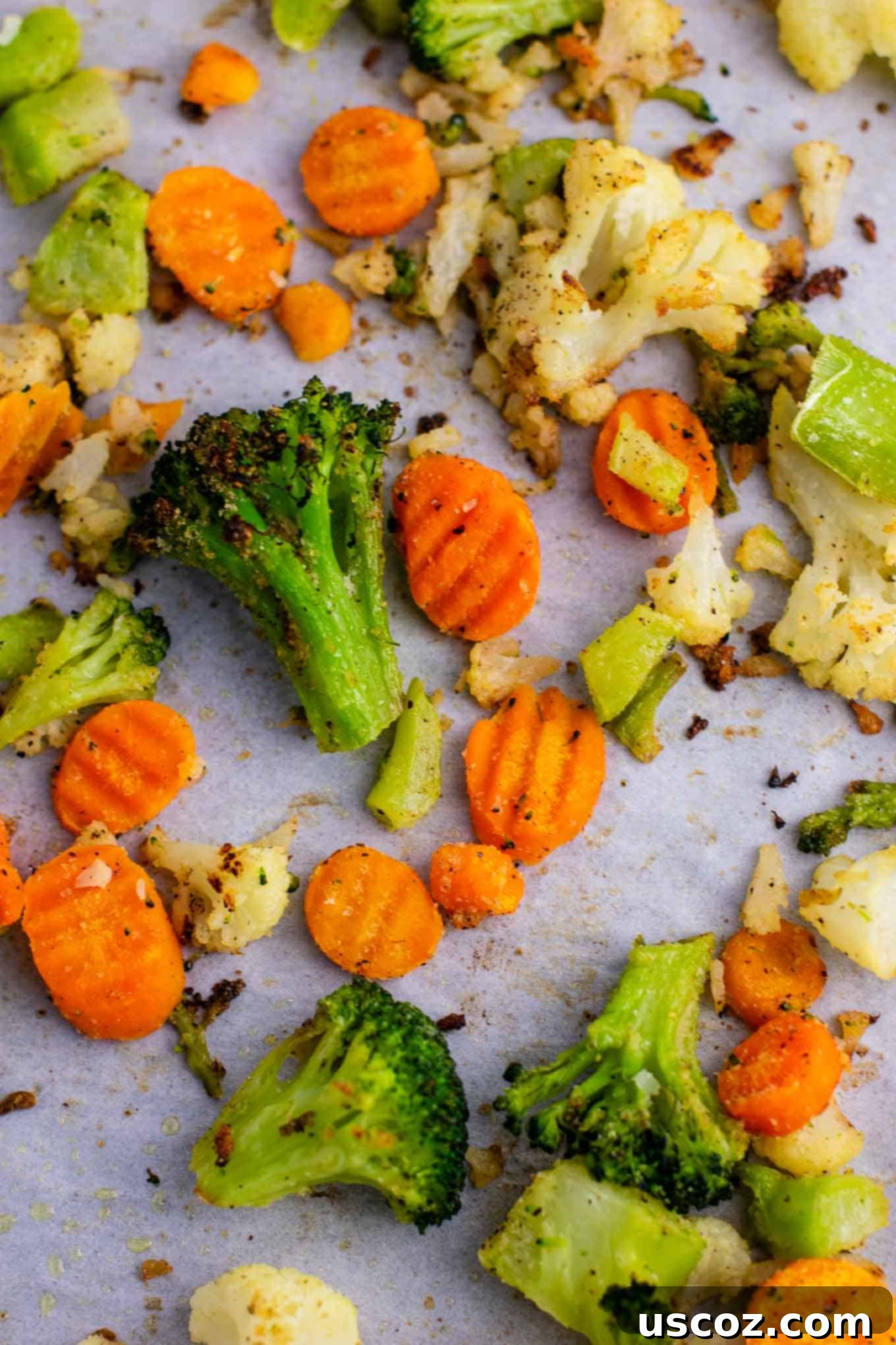 Easy Roasted Frozen Vegetables 7 Roasted carrots, cauliflower, and broccoli on a baking sheet