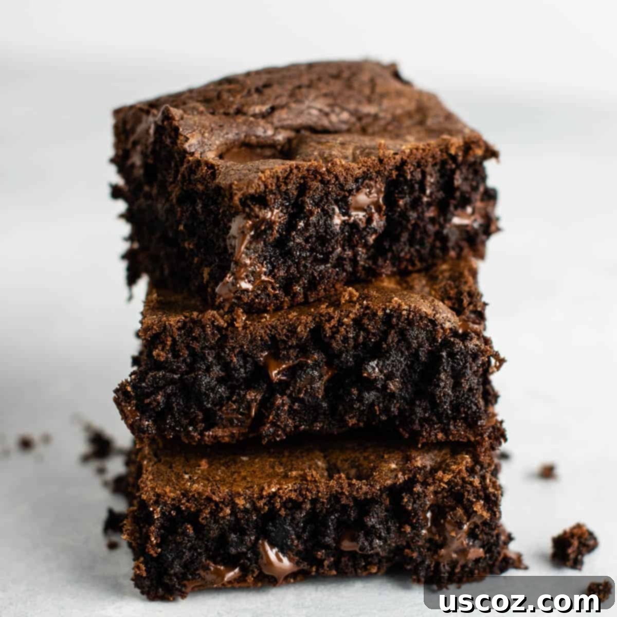 Easy Cake Mix Brownies 2 three fudgy cake mix brownies stacked on top of each other, showcasing their delicious texture