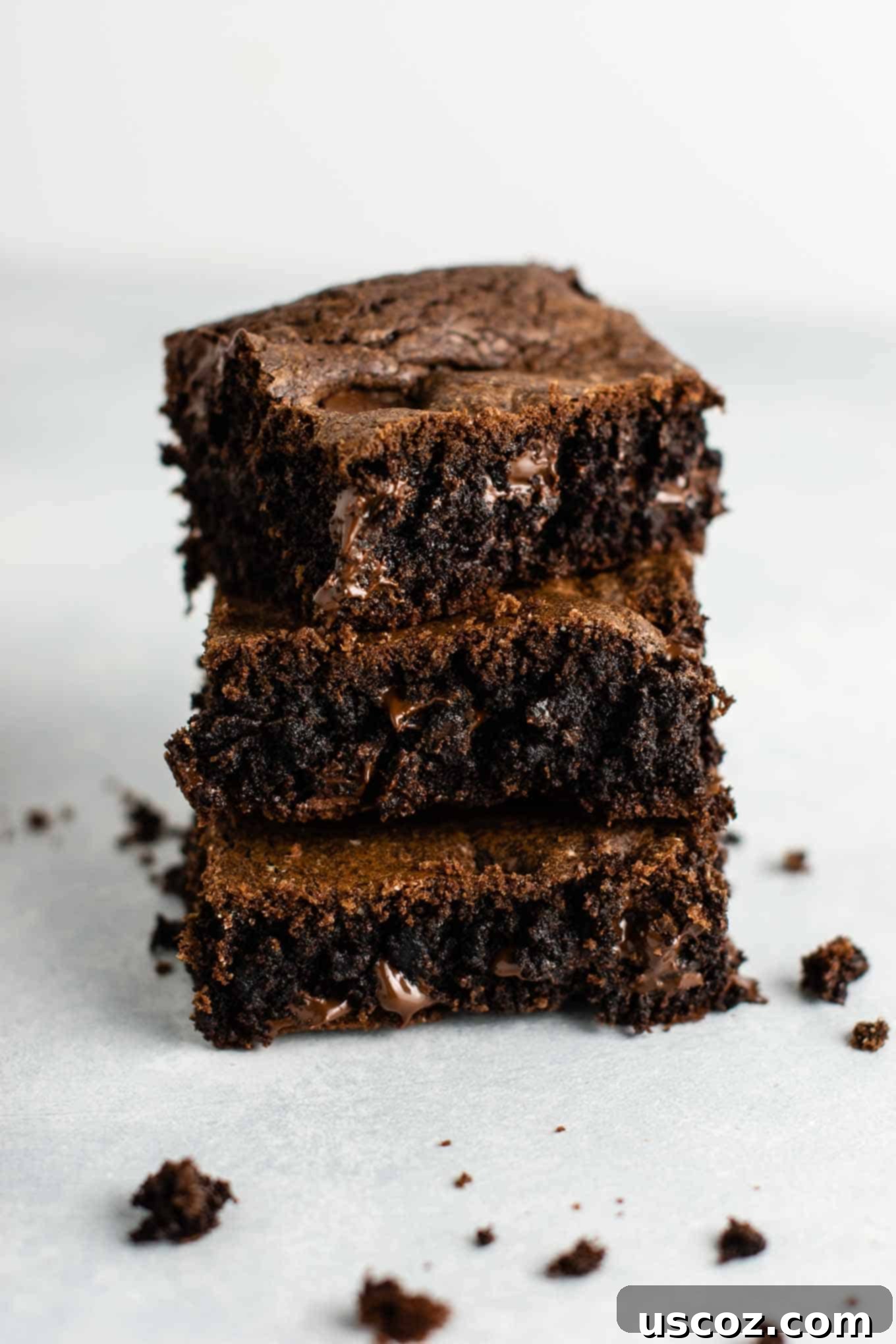 Easy Cake Mix Brownies 14 Stacked fudgy chocolate cake mix brownies, showcasing their thick and rich texture.