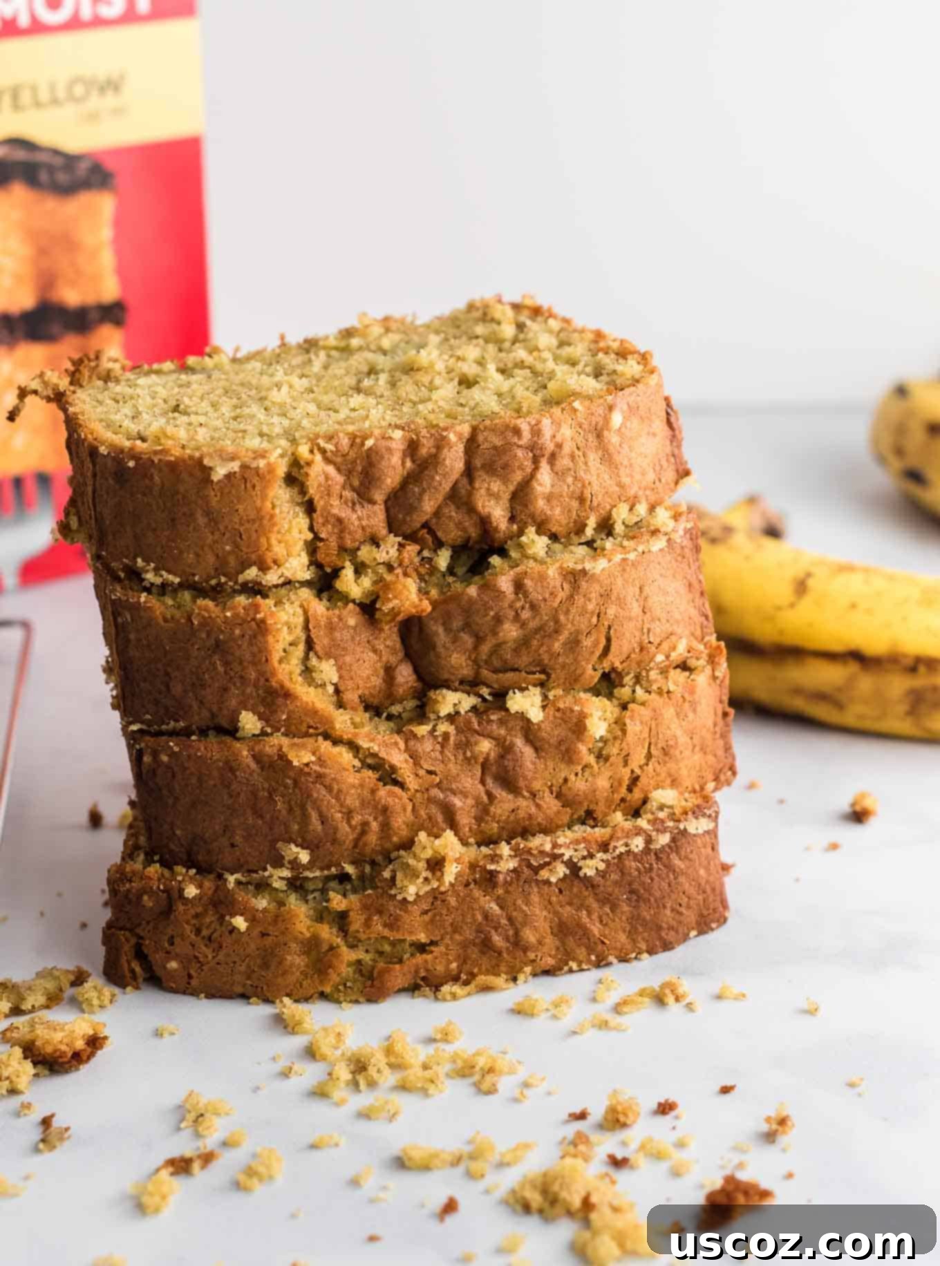Effortless Cake Mix Banana Bread 7 Four perfectly baked slices of cake mix banana bread, stacked appealingly.