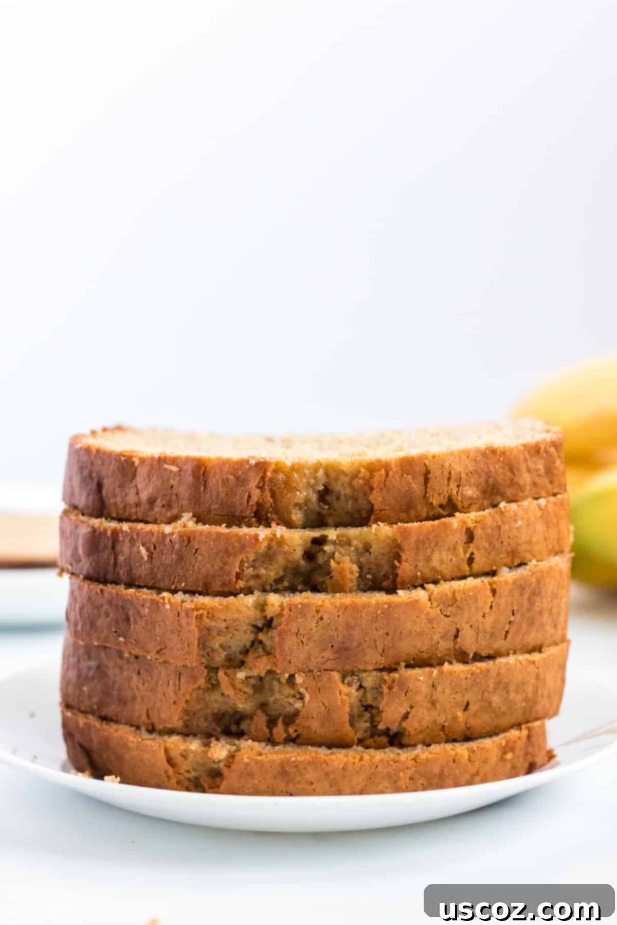 Effortless Cake Mix Banana Bread 9 A stack of perfectly sliced banana bread, ready to be served.