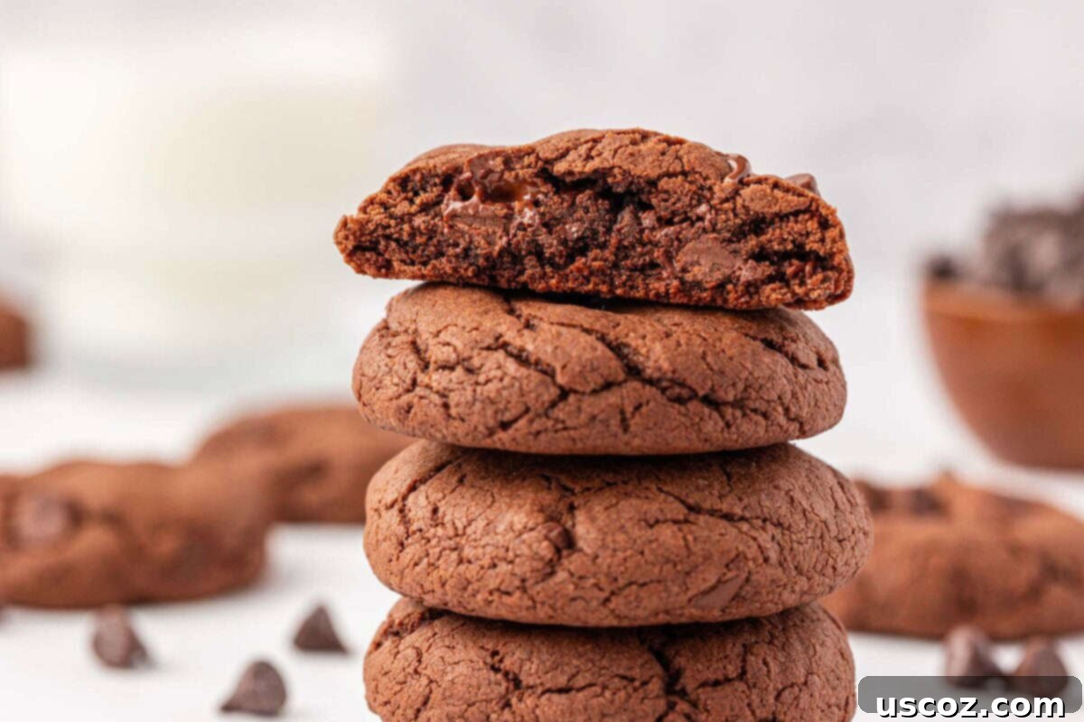 Decadent Chocolate Cake Mix Cookies 15 a stack of three chocolate cake mix cookies with visible chocolate chips